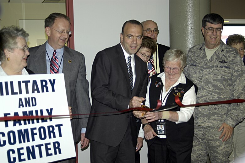 Allegheny County Executive Dan Onorato cuts the ribbon with an Airport Ambassador, officially opening the new military comfort center located at Gate A4, during a ceremony held November 18.