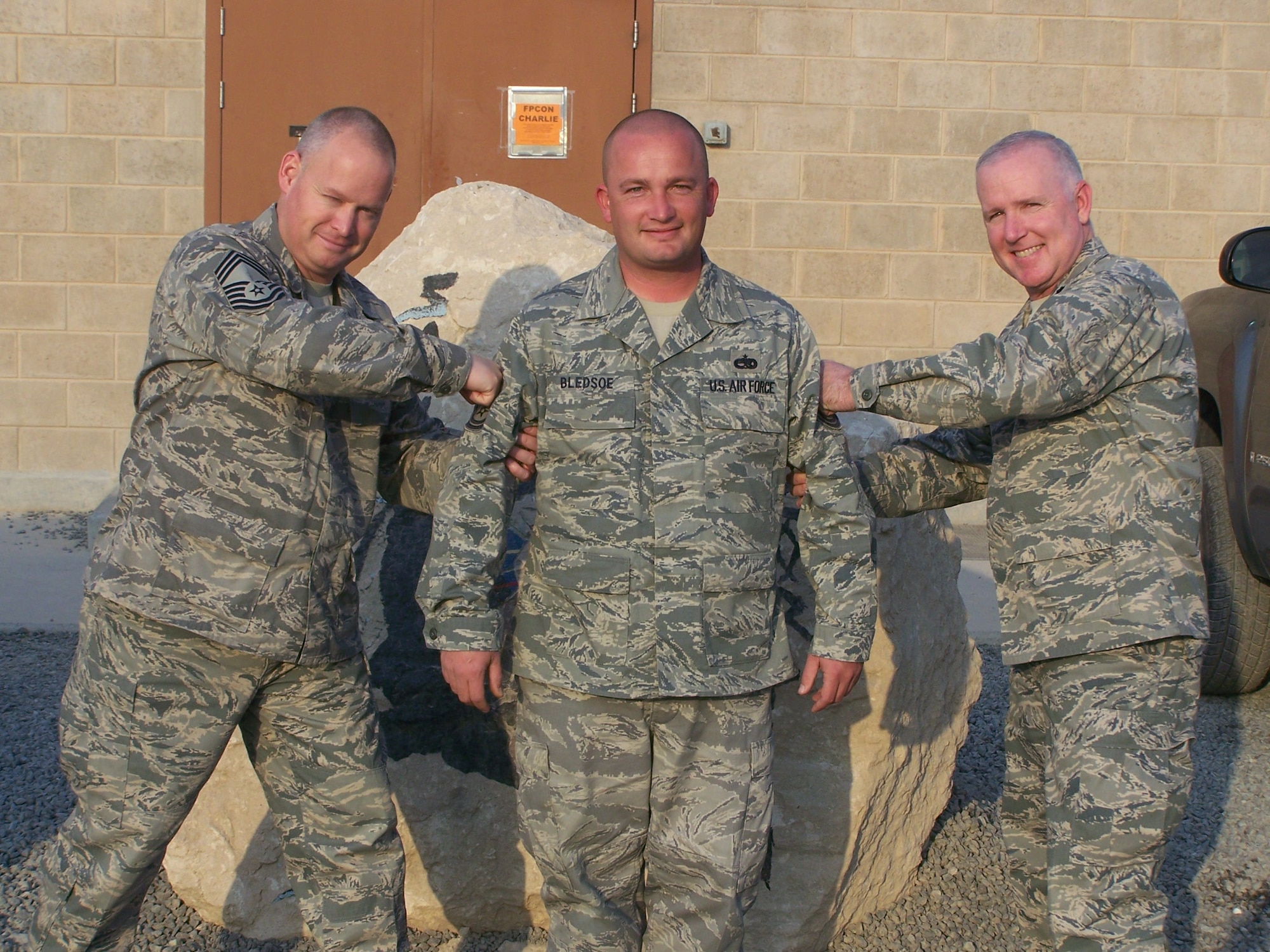 DYESS AIR FORCE BASE, Texas – Tech. Sgt Russell Bledsoe, 386th Expeditionary Aircraft Maintenance Squadron flightline expediter, was promoted to master sergeant Dec. 19 through the Stripes for Exceptional Performers program. Colonel Bernard Mater, 317th Airlift Group commander, presented Sergeant Bledsoe with his new stripe via telecom to Southwest Asia, where Sergeant Bledsoe deployed in October from the 317th Aircraft Maintenance Squadron. Lieutenant Col. Alfred Bello, 386th EAMXS commander (right), and Chief Master Sgt. Charles Smith, squadron superintendent (left), physically presented Sergeant Bledsoe (center) with the stripe. His wife, Noelle Bledsoe, was present during the telecom. Covert communication between the desert and home station ensured both Sergeant and Mrs. Bledsoe were surprised. "Mrs. Bledsoe was originally concerned to receive an early-morning call from me asking her to come by my office, but I assured her all was fine,” said Chief Master Sgt. James Collins, 317th AMXS superintendent. “Afterward, she informed me the trip was well worth it, and it will be a well-remembered Christmas." (Courtesy photo)