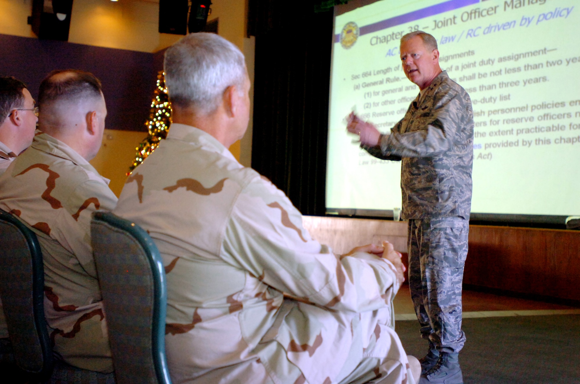 Air Force Maj. Gen. Jim Graves, the assistant to the Chairman of the Joint Chiefs of Staff for Reserve Affairs, gives a slideshow presentation to National Guard and Reserve members at U.S. Naval Station Guantanamo Bay, Dec. 10. Graves spoke on the importance of joint service experience within the military as well as joint service rank advancement aspects specific to reserve component troops. (Army photo by Pfc. Eric Liesse)
