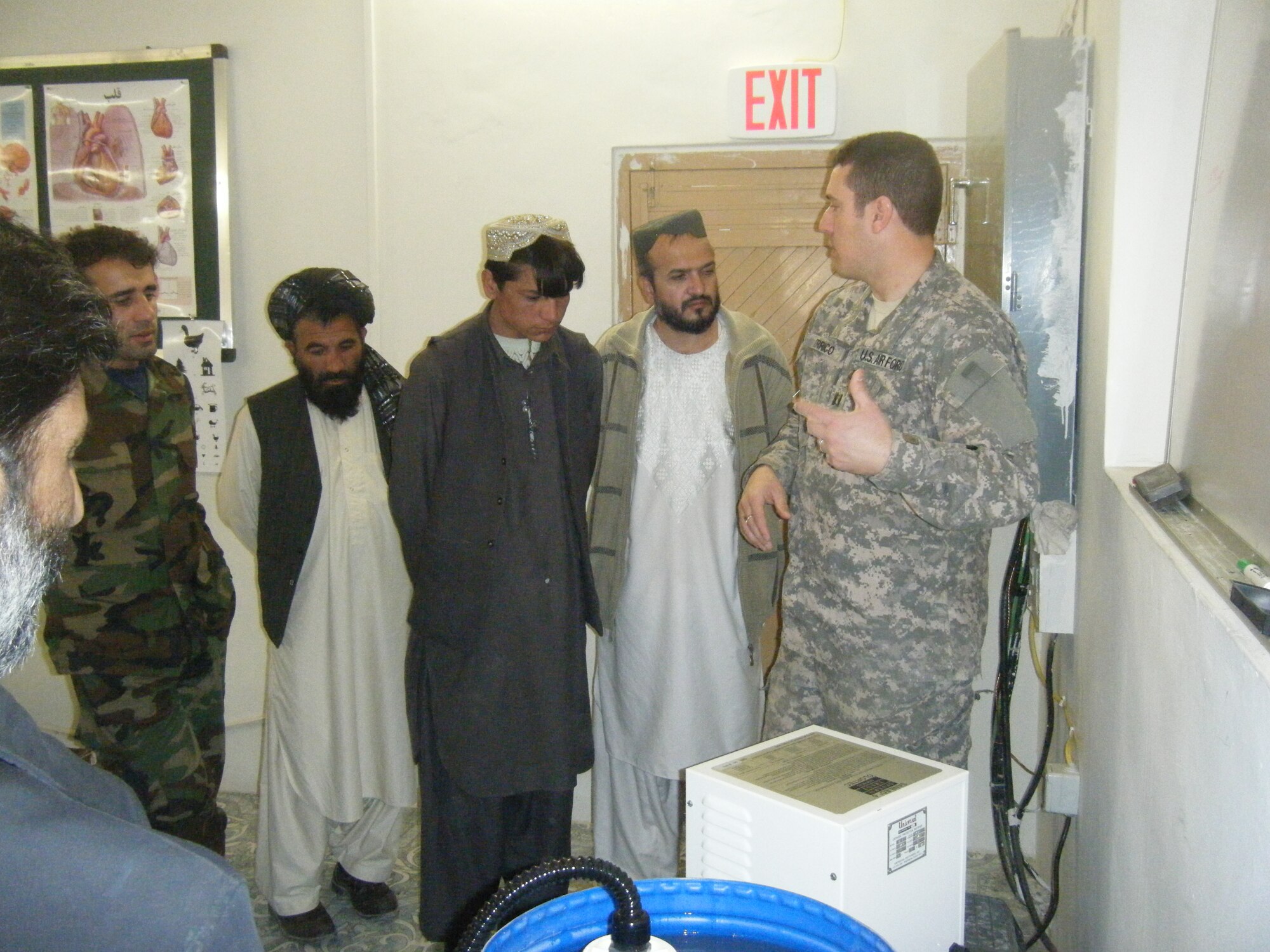 Air Force Dr. (Capt.) Bill Errico instructs doctors from Zabul on how to properly use the ionizer. The Medical team from Zabul PRT donated water purification systems to hospitals throughout Zabul. (U.S. Air Force photo by Airman 1st Class Mary Costello)