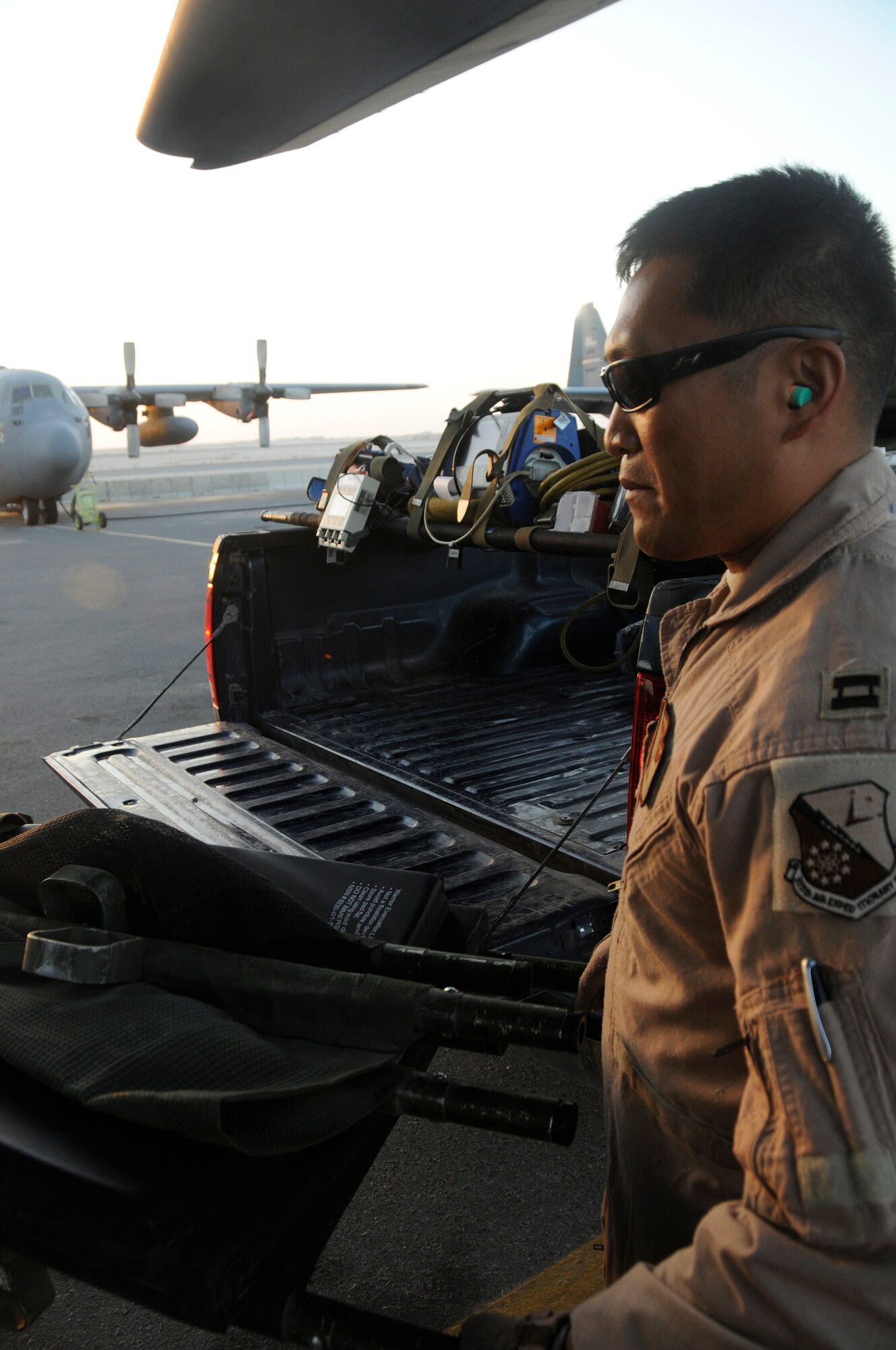 Captain Tim Bougie, a flight nurse assigned to the 379th Expeditionary Aeromedical Evacuation Squadron, carries a litter filled with aeromedical equipment onto a C-130 as part of setting up for an air evacuation of injured personnel Dec. 29, 2008, at an undisclosed air base in Southwest Asia. He is responsible for evacuating injured personnel from the area of responsibility and providing medical assistance until they arrive at a medical facility. Captain Bougie, a native of Minneapolis, Minn., is deployed from the Minnesota Air National Guard, in support of Operations Iraqi and Enduring Freedom and Joint Task Force-Horn of Africa. (U.S. Air Force photo by Staff Sgt. Darnell T. Cannady/Released)