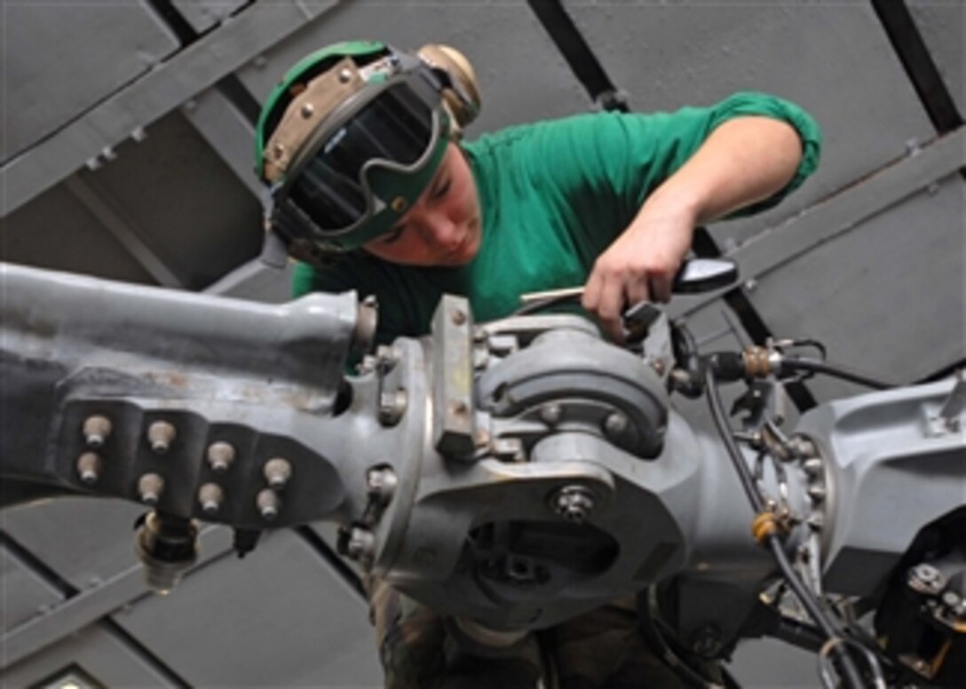 U.S. Navy Petty Officer 3rd Class Corinna Benz, assigned to Helicopter Antisubmarine Squadron 3, installs a blade-fold harness on a rotor blade of an SH-60F Seahawk helicopter aboard the aircraft carrier USS Theodore Roosevelt (CVN 71) underway in the Gulf of Oman on Dec. 2, 2008.  The aircraft carrier and embarked Carrier Air Wing 8 are on deployment in the 5th Fleet area of responsibility and are focused on reassuring regional partners of the United Statesí commitment to security.  