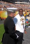 2nd Lt. Raymond Galbreth, Camp Lejeune, N.C., and former Iowa Hawkeye quarterback and Heisman Trophy runner-up Brad Banks discuss football during action at the Outback Bowl Jan. 1 at Raymond James Stadium in Tampa, Fl. Galbreath was honored at halftime of the game for being a Marine alumni from the University of Iowa.