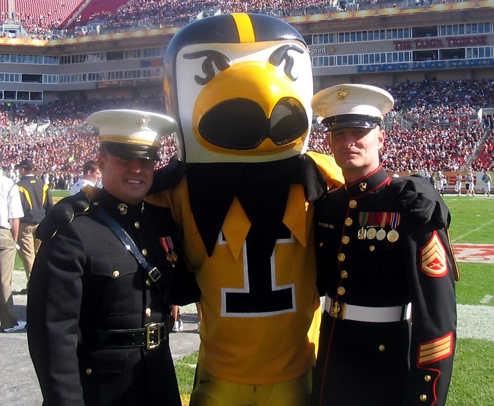 2nd Lt. Raymond Galbreth, Camp Lejeune, N.C., Herky the Iowa Hawkeyes mascot, and Staff Sgt. Brandon Swenson, 9th Marine Corps District, take time during a break in the action at the Outback Bowl for a picture. Galbreath and Swenson represented Marine alumni from the University of Iowa at the Outback Bowl Jan. 1 at Raymond James Stadium in Tampa, Fl.