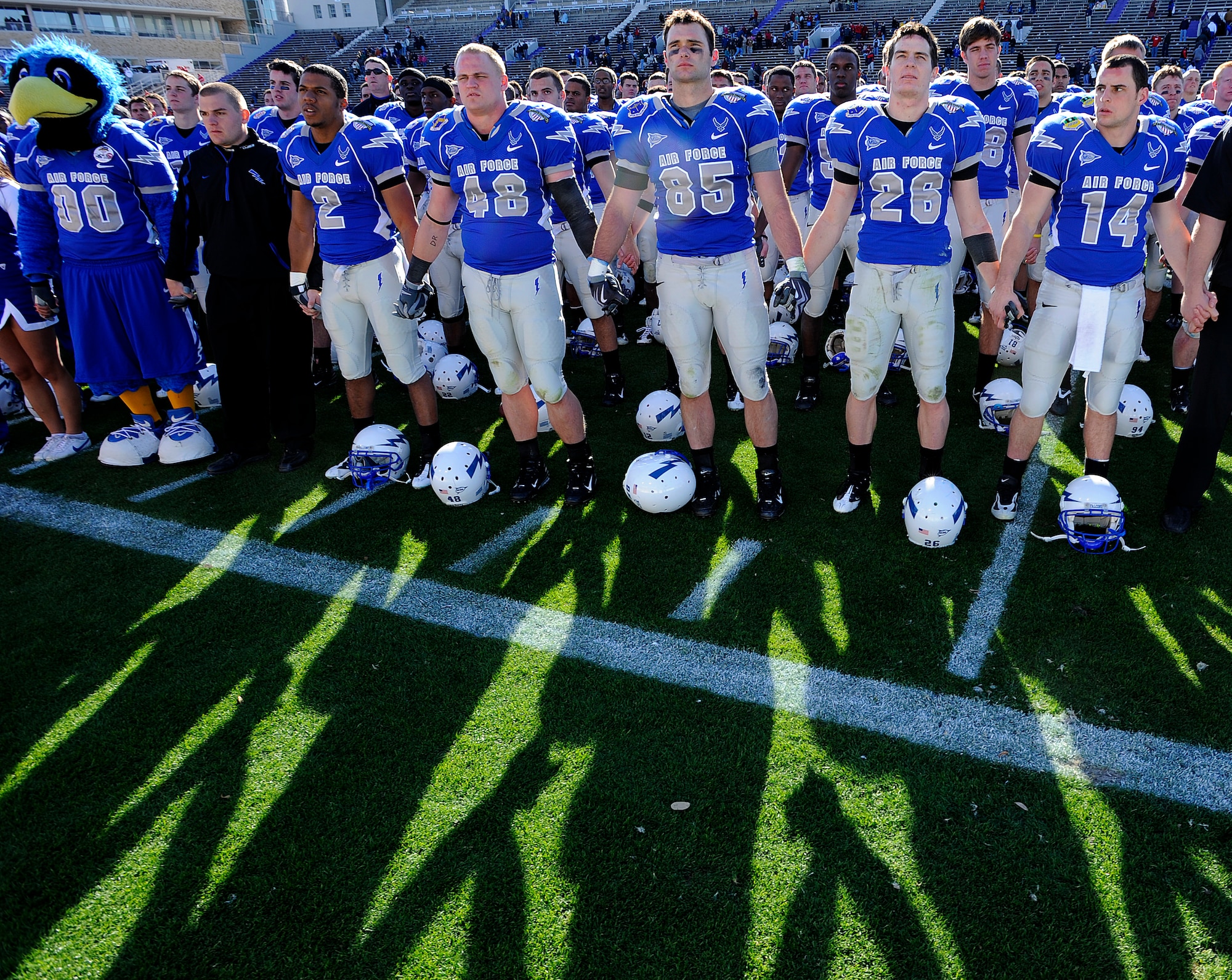 U.S. Air Force Academy football players stand together in honoring alumni and fans at the conclusion of the Bell Helicopter Armed Forces Bowl game between the U.S. Air Force Academy and the University of Houston Dec. 31 in Fort Worth, Texas. Air Force lost to Houston, 34-28. (U.S. Air Force photo/Staff Sgt. Bennie J. Davis III)