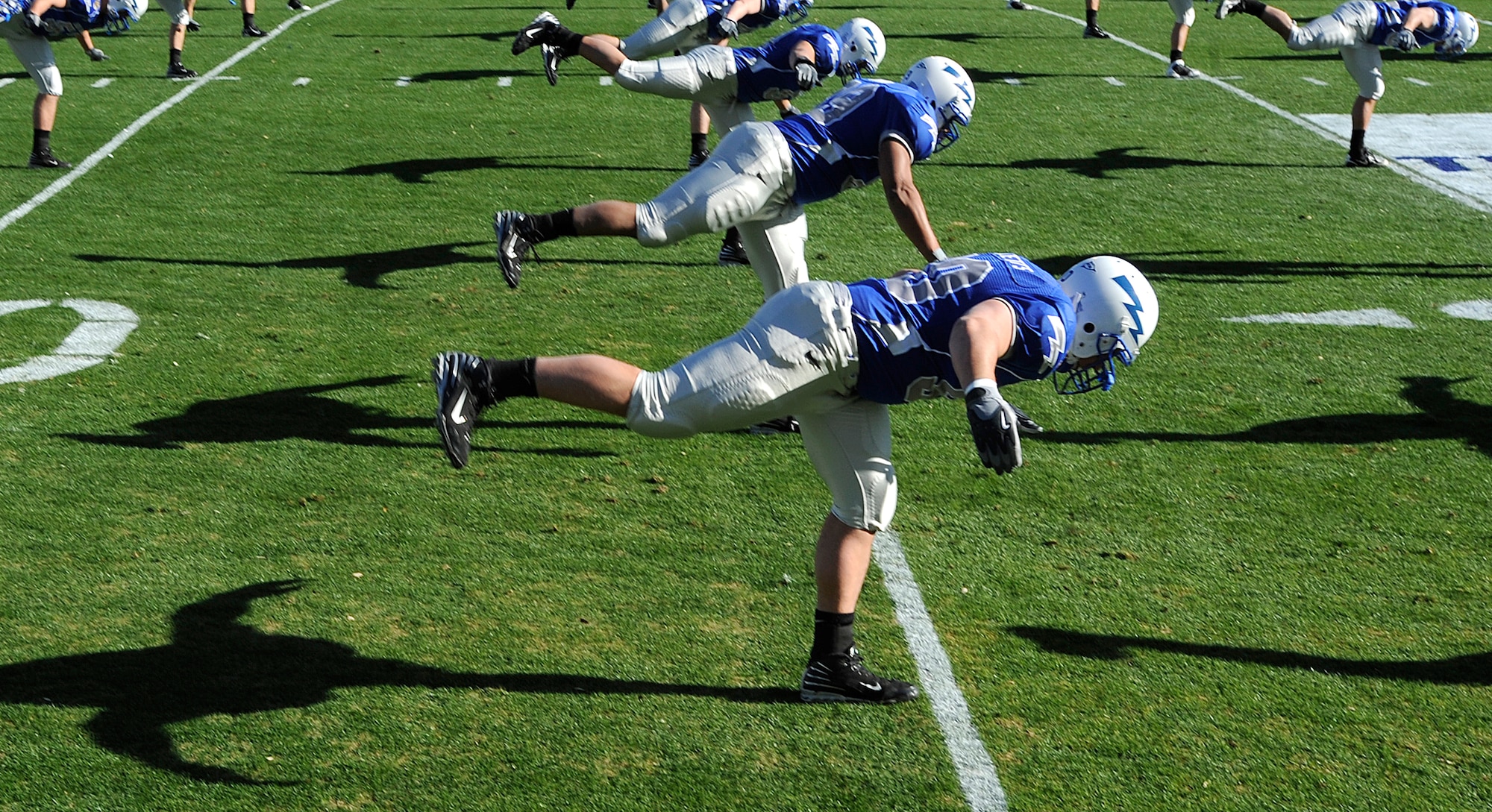 U.S. Air Force Academy Falcon football players stretch before the Bell Helicopter Armed Forces Bowl game between the Falcons and the University of Houston Cougars on Dec. 31 at the Amon G. Carter Stadium, Fort Worth, Texas. (U.S. Air Force photo/Staff Sgt. Bennie J. Davis III)