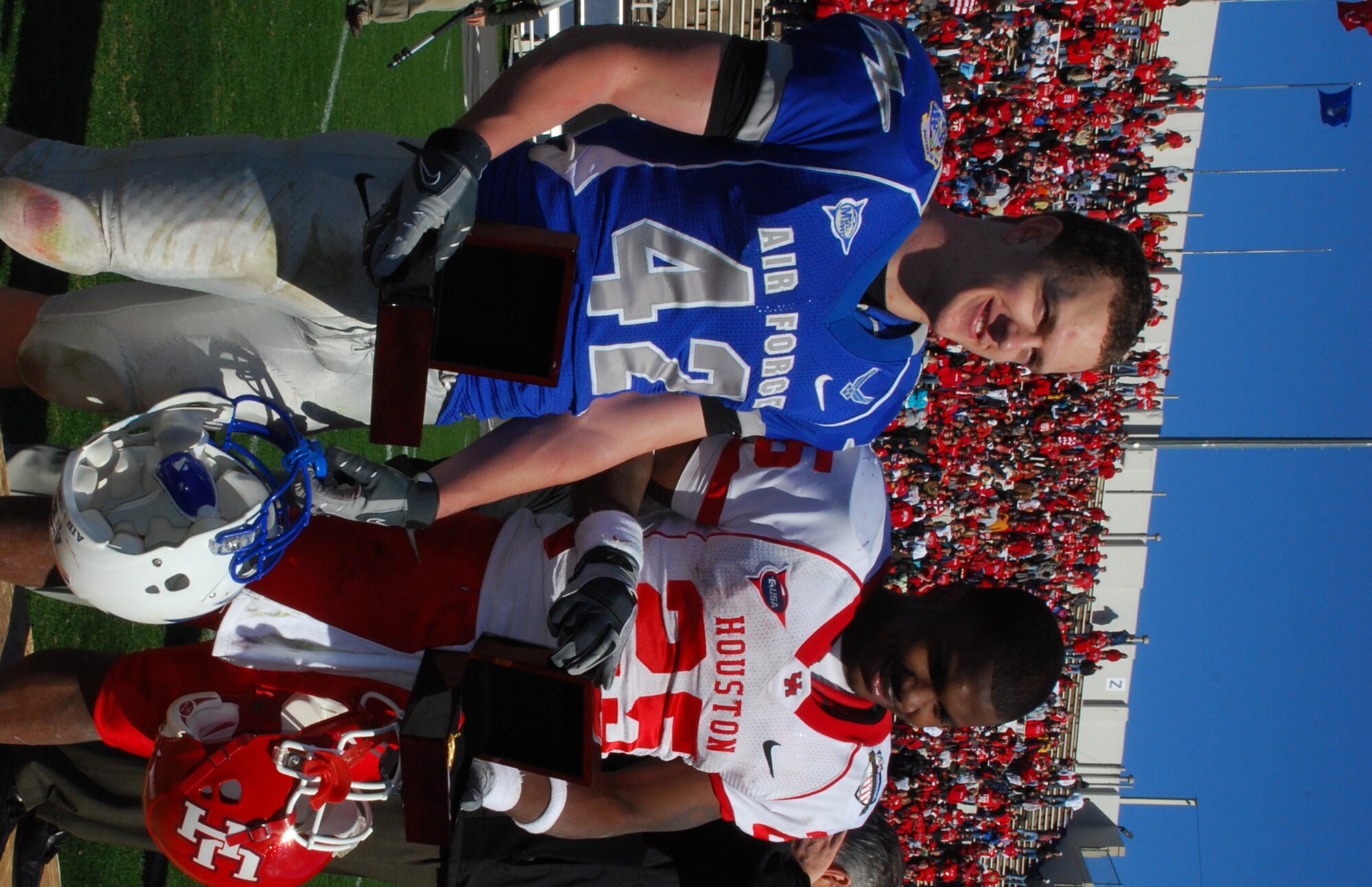 The 2008 Armed Forces Bowl Most Valuable Players accept their award in front of a Fort Worth, Texas crowd. Air Force MVP was fullback sophomore Jared Tew and Houston's MVP was freshman running back, Bryce Beall. The cougars defeated the falcons, 34 to 28. (U.S. Air Force Photo/Tech. Sgt. Julie Briden-Garcia)