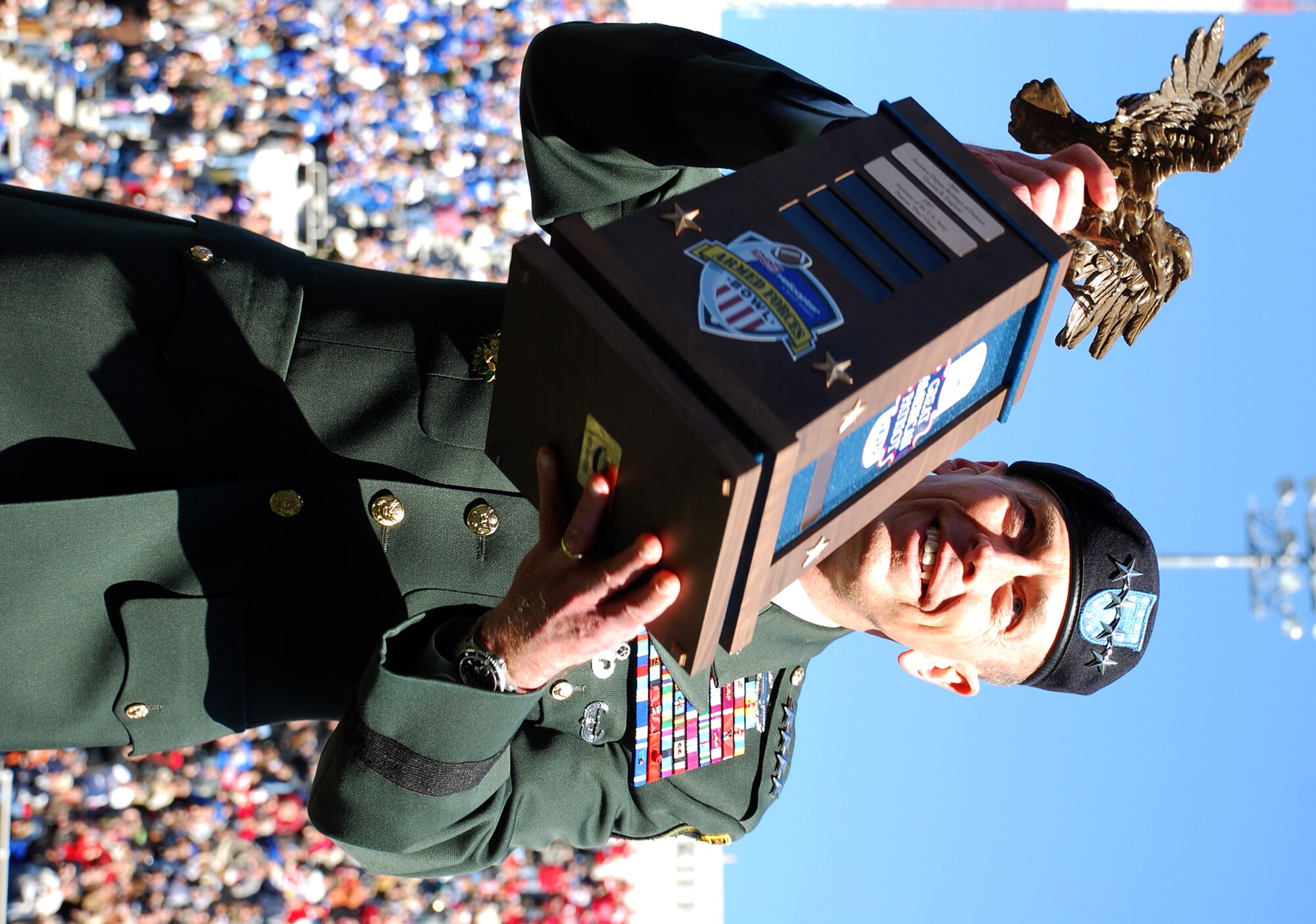 General David H. Petraeus, U.S. Central Command commander, accepts the Armed Forces Insurance Great American Patriot Award during halftime activities at this year's Armed Forces Bowl in Fort Worth, Texas. The Air Force Academy fell to the University of Houston, 28 to 34. (U.S. Air Force Photo/Tech. Sgt. Julie Briden-Garcia)