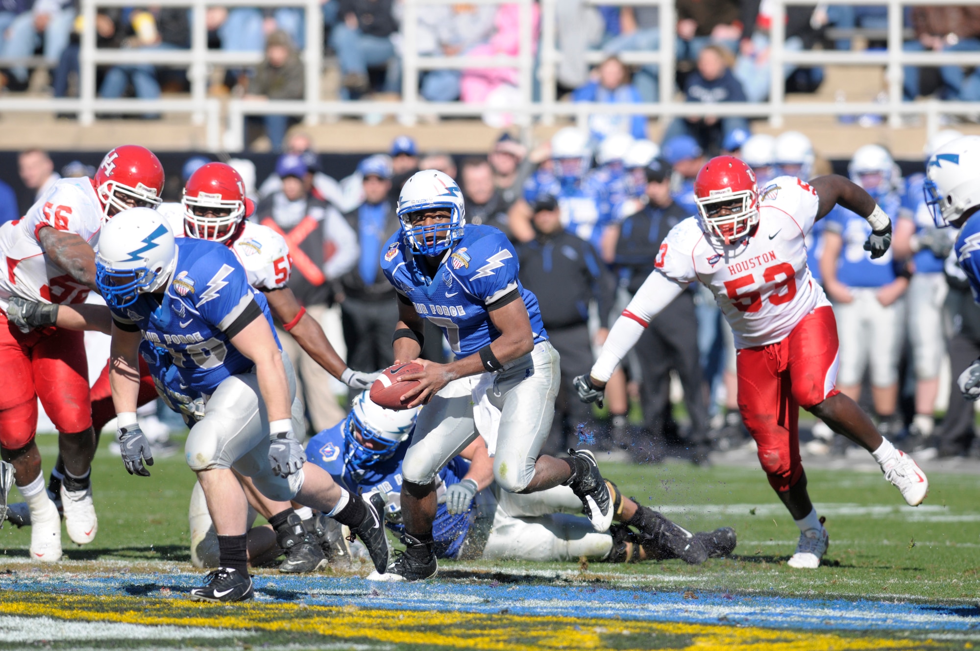 Under pressure, U.S. Air Force Academy quarterback Tim Jefferson looks to pitch the ball to a running back during the sixth annual Bell Helicoptor Armed Forces Bowl Dec. 31. The Academy set a new Armed Forces Bowl game rushing yardage record, running 67 times for 243 yards, but fell short of beating the University of Houston Cougars, 34-28. (U.S. Air Force photo/David Armer)