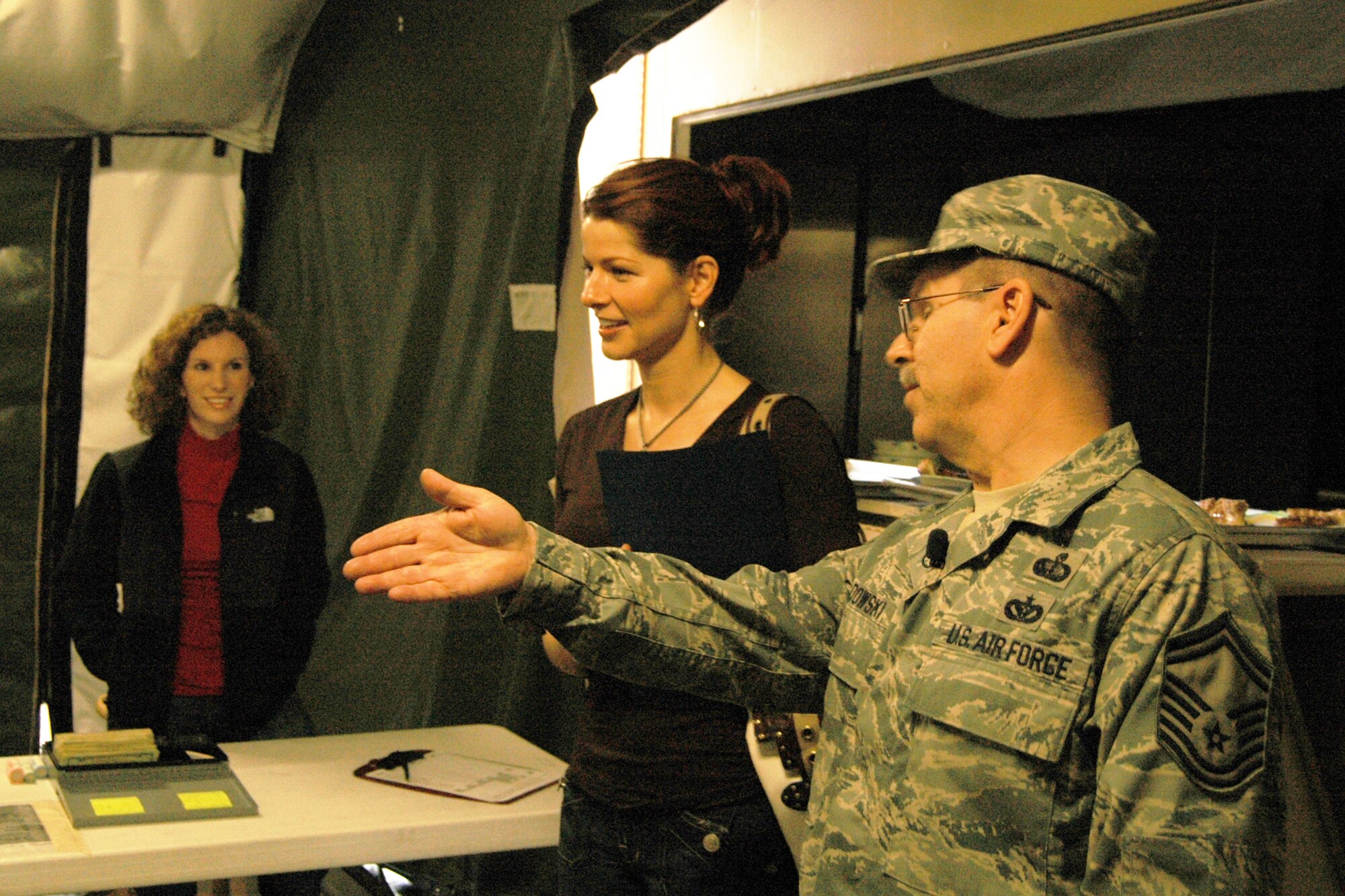 12/31/08 - Senior Master Sgt. Steven Baldowski, Combat Services superintendent, briefs CBS46 TV reporter Dagmar Midcap on operations in the combat dining facility.   Air Force Services personnel are trained at the Air Force Reserve Command Services Combat Training Center in preparation for field duty.  (U.S. Air Force photo/Master Sgt. Stan Coleman)