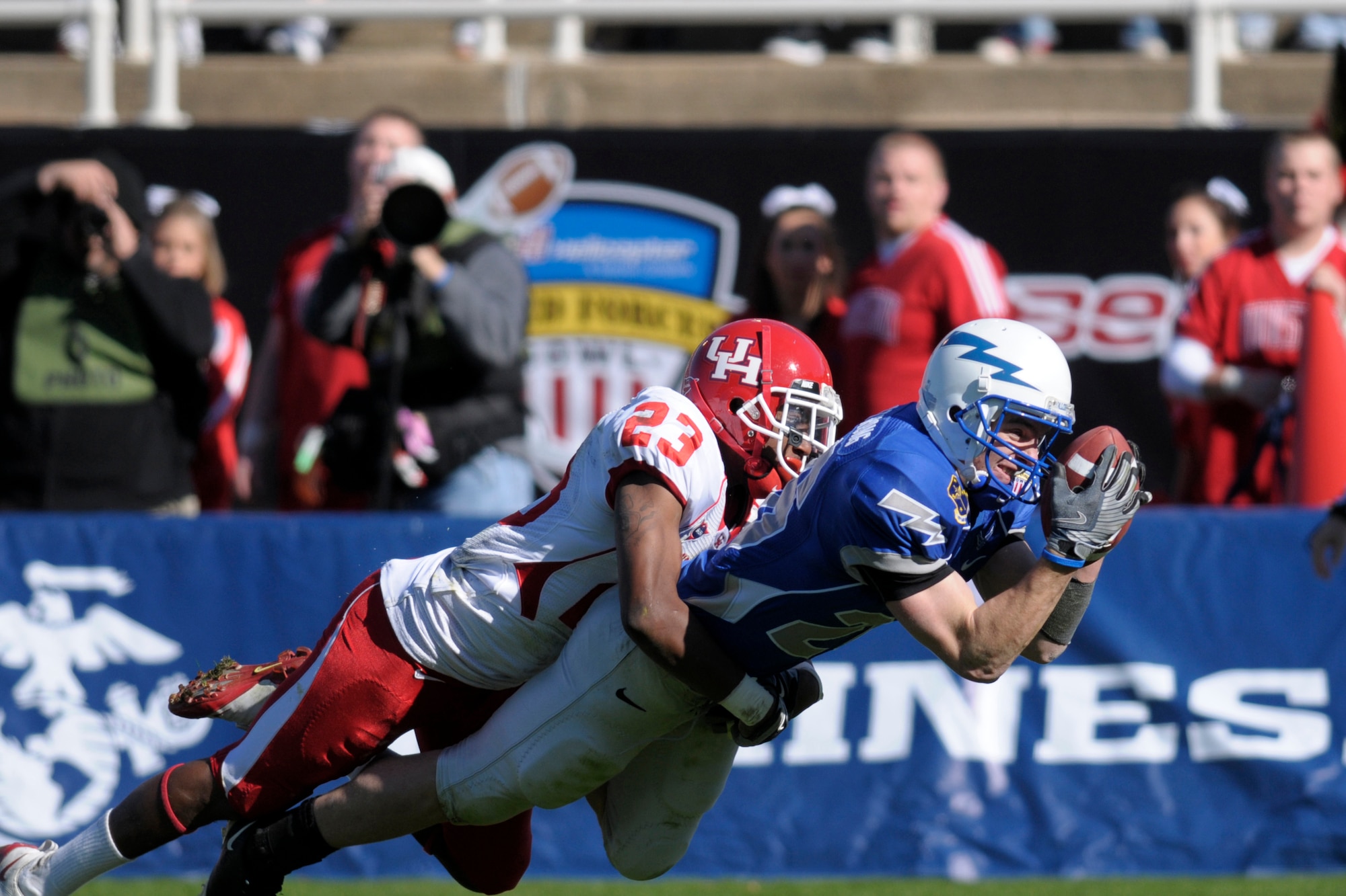 U.S. Air Force Academy wide receiver Spencer Armstrong pulls in a long bomb for a 46-yard gain during the Bell Helicoptor Armed Forces Bowl Dec. 31. Only the tackle of University of Houston safety Carson Blackmon kept Armstrong out of the end zone on this play. Houston beat the Air Force Academy, 34-28. (U.S. Air Force photo/David Armer)