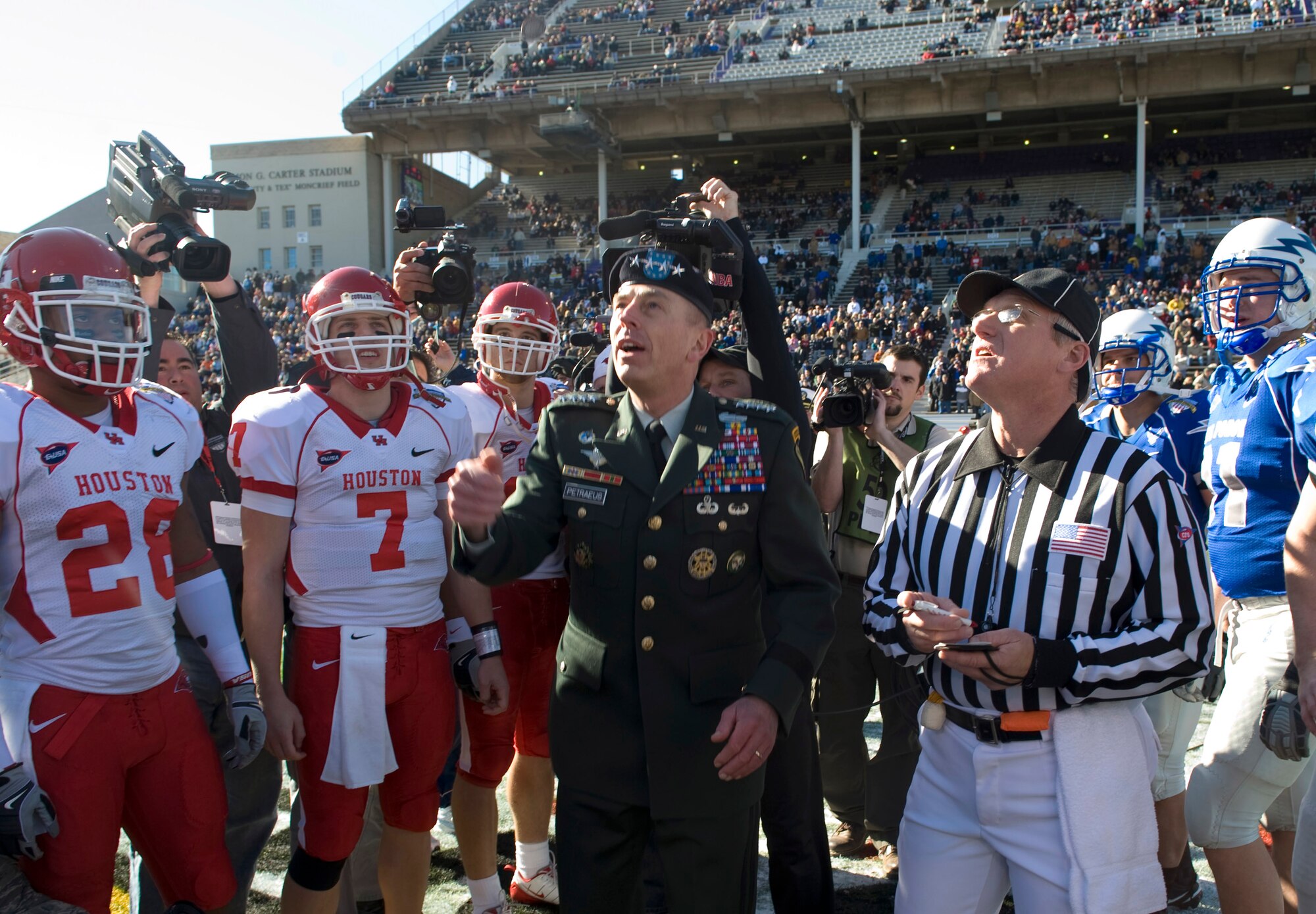 U.S. Army Gen. David Petraeus, U.S. Central Command commander, performs the coin toss before the sixth annual Bell Helicopter Armed Forces Bowl Dec. 31 in Fort Worth, Texas. Taking part in the bowl game are the University of Houston Cougars and the U.S. Air Force Academy Falcons. Besides performing the coin toss, General Petraeus is being honored during the game's half-time event. (Department of Defense photo/Petty Officer Jhi L. Scott)