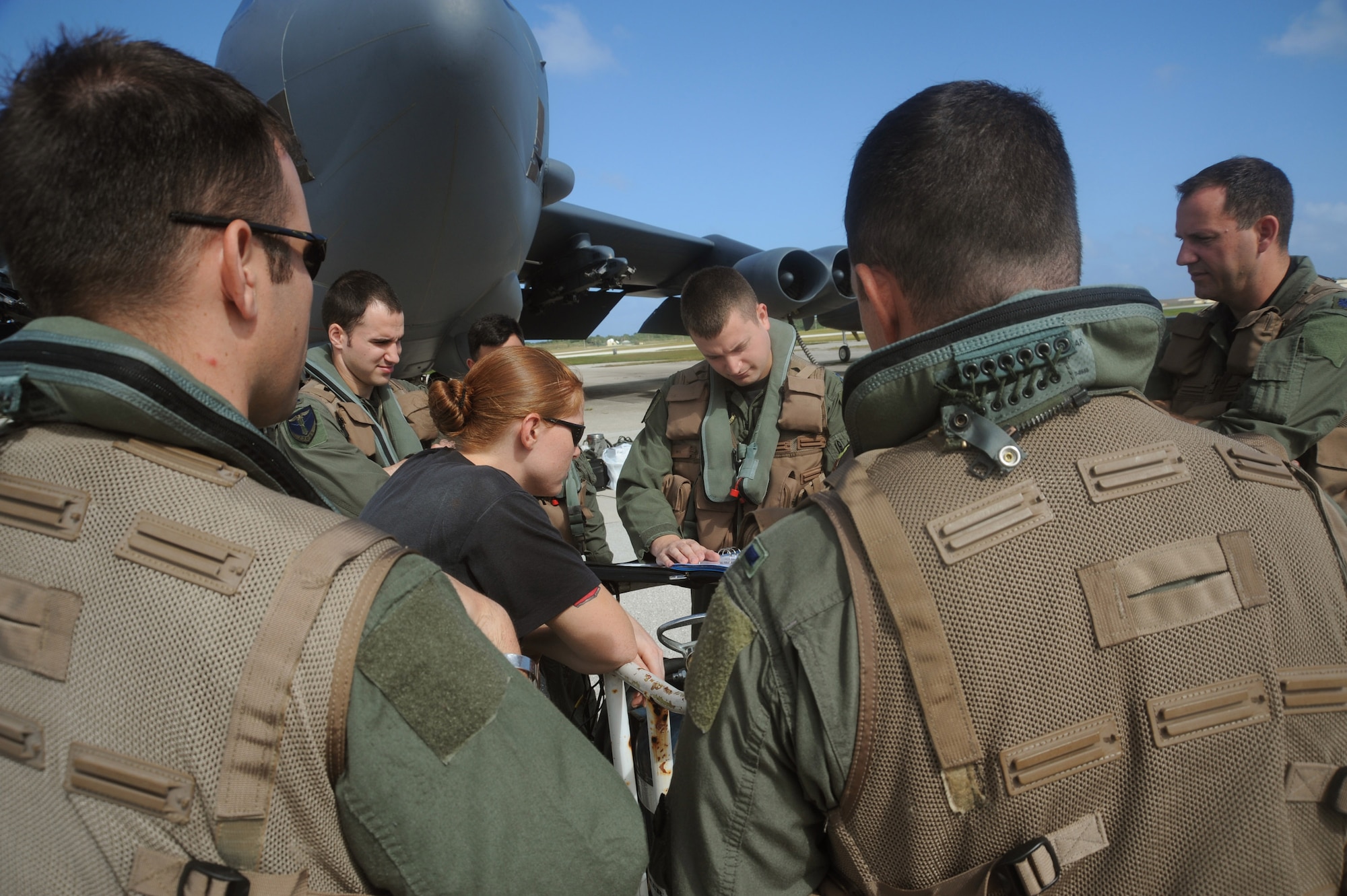 Pilots from the 23rd Expeditionary Bomber Squadron and 36th Expeditionary Aircraft Maintenance Squadron members review aircraft forms Dec. 30 before a B-52 Stratofortress mission. All are deployed to Andersen Air Force Base, Guam from Minot AFB, N.D. The bomber's participation in constant training helps emphasize the U.S. bomber presence, demonstrating U.S. commitment to the Pacific region. (U.S. Air Force photo/Master Sgt. Kevin J. Gruenwald)