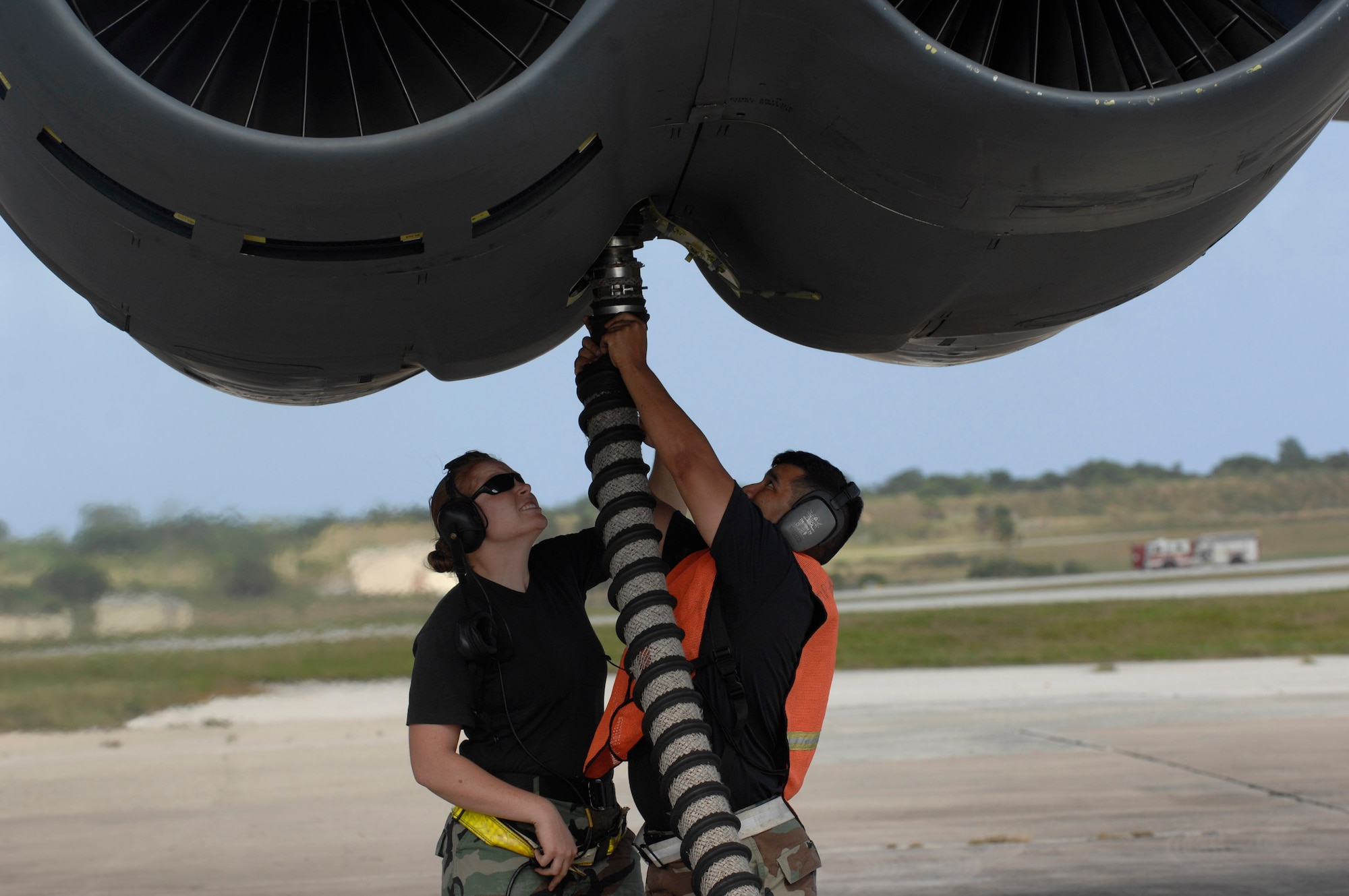 Airman 1st Class Caroline Kraus and Tech. Sgt. Carlos Sanchez remove the air cart hose after starting engines Dec. 30, during a B-52 Stratofortress launch at Andersen Air Force Base, Guam. Both are assigned to the 36th Expeditionary Aircraft Maintenance Squadron at Andersen and are deployed from Minot AFB, N.D. The bomber's participation in constant training helps emphasize the U.S. bomber presence, demonstrating U.S. commitment to the Pacific region. (U.S. Air Force photo/Master Sgt. Kevin J. Gruenwald)