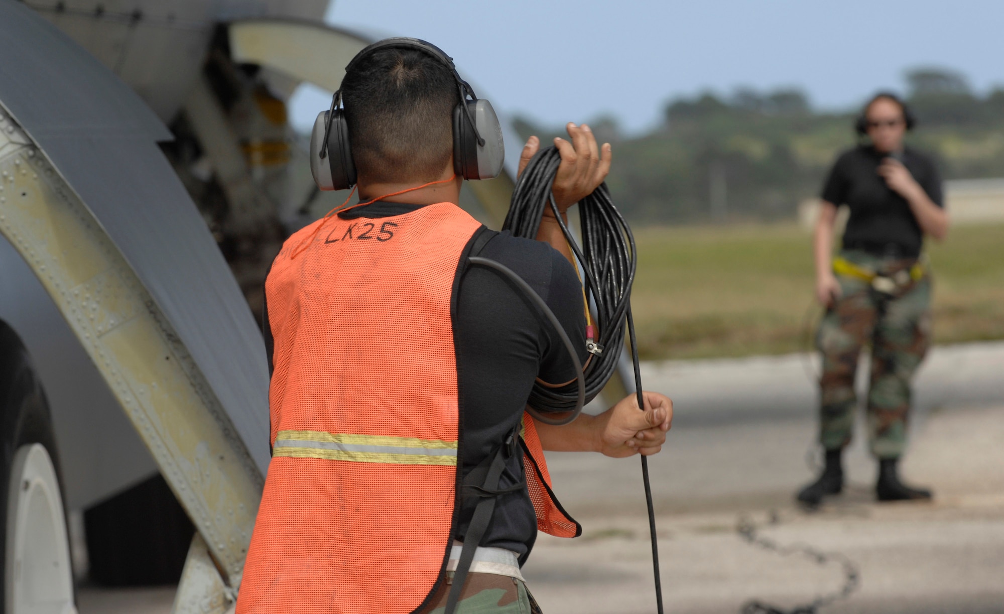 Tech. Sgt. Carlos Sanchez wraps up a communication cord Dec. 30, while Airman 1st Class Caroline Kraus checks in with aircrew during a B-52 Stratofortress launch at Andersen Air Force Base, Guam. Both are assigned to the 36th Expeditionary Aircraft Maintenance Squadron at Andersen and are deployed from Minot AFB, N.D. The bomber's participation in constant training helps emphasize the U.S. bomber presence, demonstrating U.S. commitment to the Pacific region. (U.S. Air Force photo/Master Sgt. Kevin J. Gruenwald)