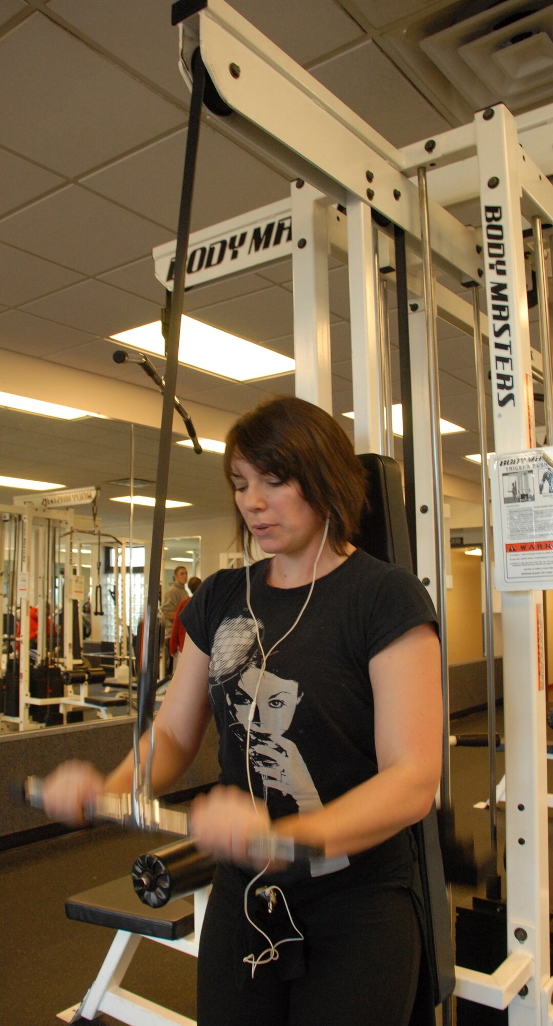 DOVER AIR FORCE BASE, Del. ? Tech. Sgt. Rhonda Fujan, 709th Airlift Squadron, uses the triceps pushdown machine at the Fitness Center. The Reservist says she wants to reduce her texting on the phone and make more phone calls instead. (U.S. Air Force photo/ Airman 1st Class Shen-Chia Chu)