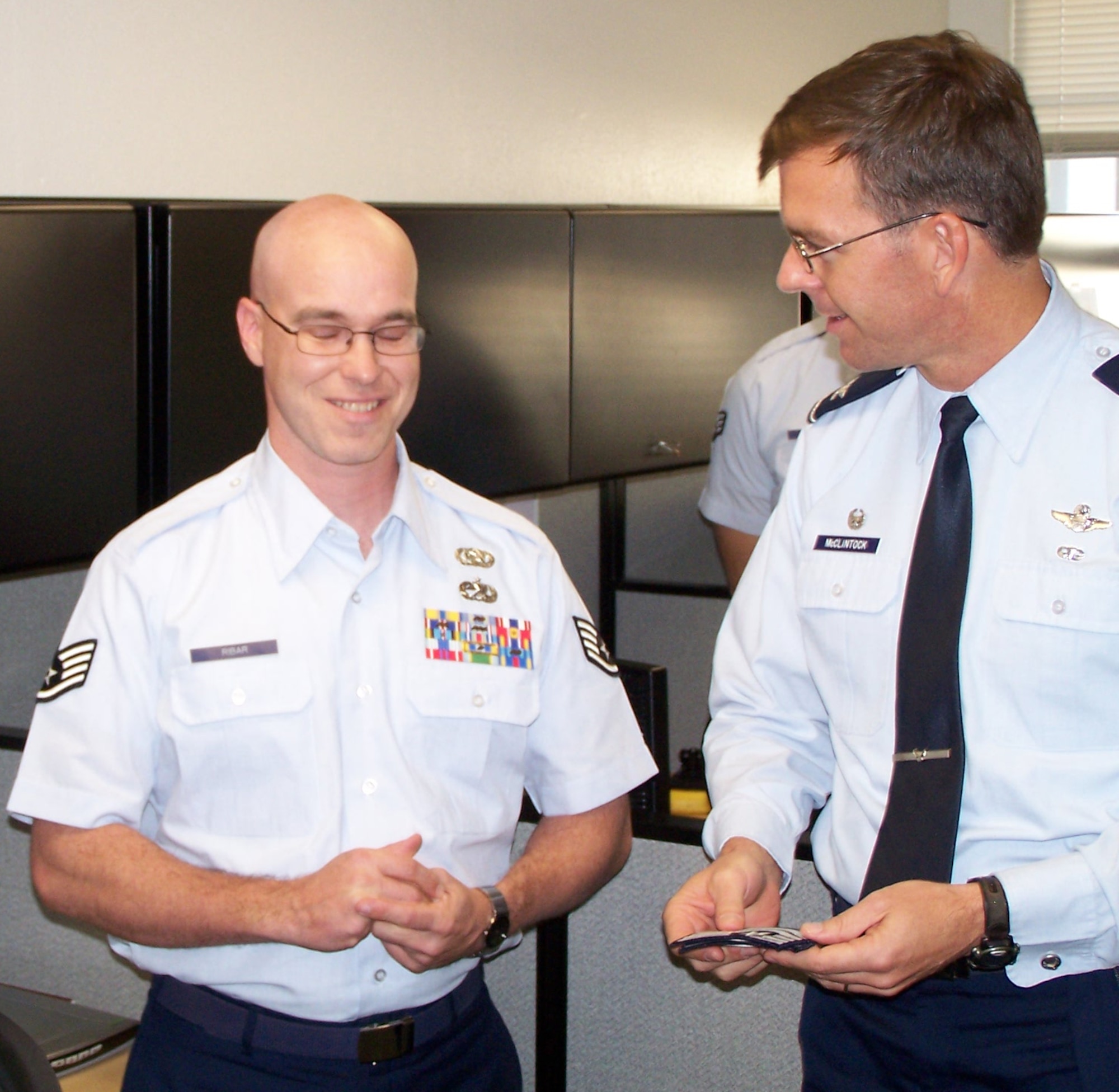EGLIN AIR FORCE BASE, Fla. -- Col. Bruce McClintock, 96th Air Base Wing commander, presents technical sergeant stripes to Tech. Sgt. Joseph Ribar, 96th Communications Group, who earned the promotion under the Stripes for Exceptional Performers program. (Courtesy photo)