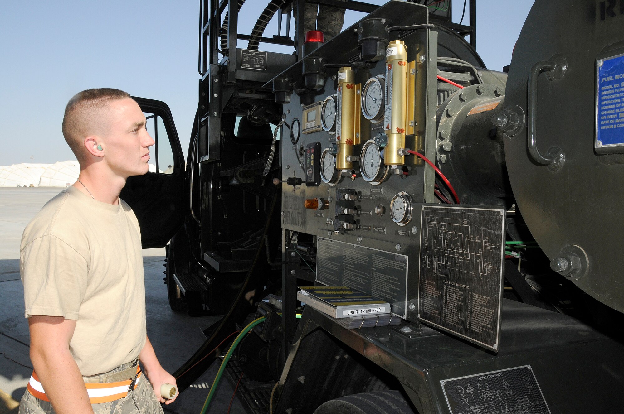 SOUTHWEST ASIA -- Airman 1st Class Stuart Brennan from the 380th Expeditionary Logistics Readiness Squadron checks his gauges while he uses a "dead man" to refuel a KC-10 Extender here. This is a device that the fuels Airmen use to ensure there is a constant flow maintained during refueling. Airman Brennan has to grip the "dead man" and release it within 90 seconds continually throughout the refueling process. The average fuel transfer rate is 600 gallons per minute. Airman Brennan is deployed from the 20th LRS, Shaw Air Force Base, S.C., his hometown is Westerly, R.I. (U.S. Air Force photo/Tech. Sgt. Christopher A. Campbell) (released)