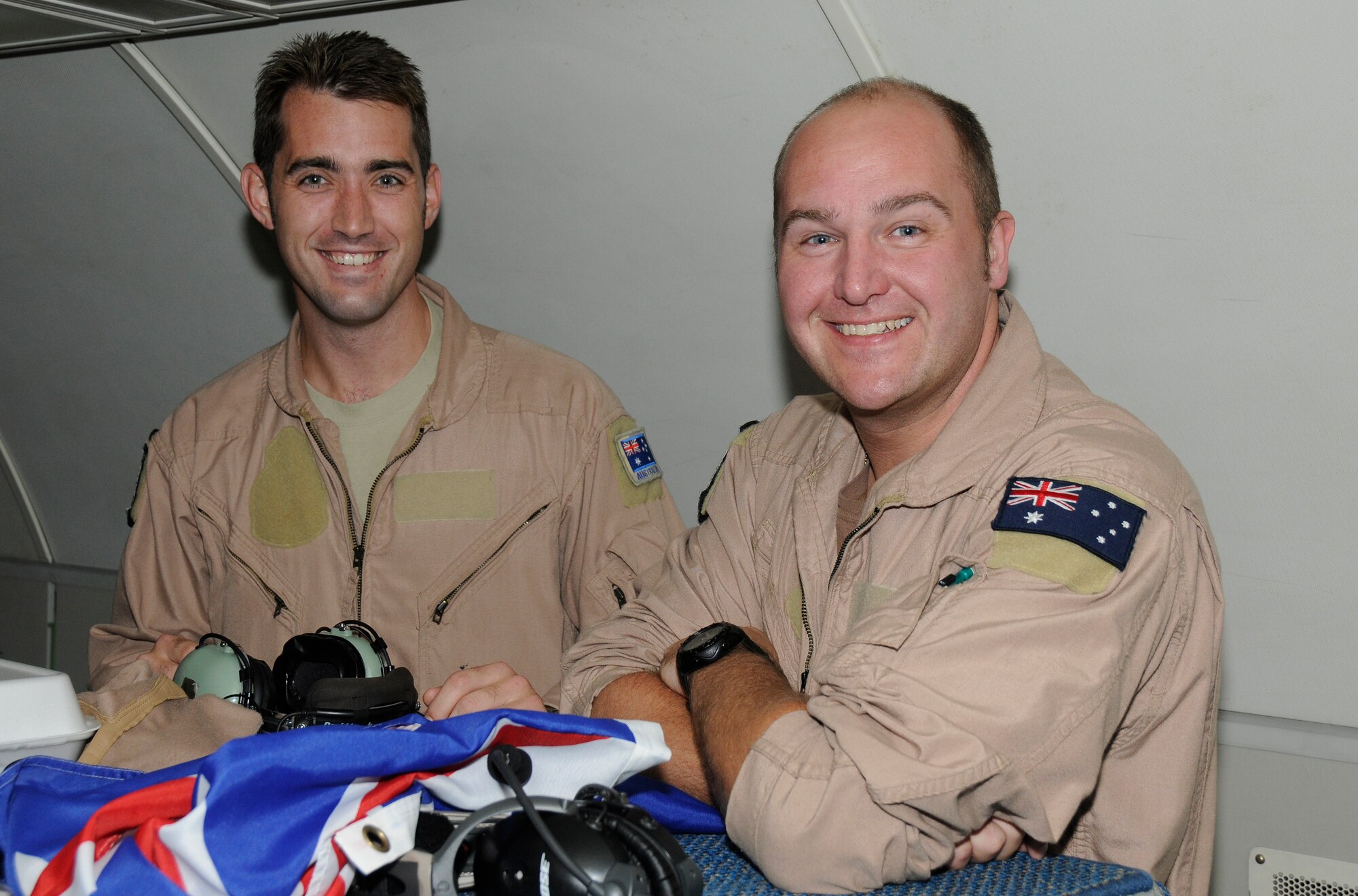SOUTHWEST ASIA -- Flight Lieutenants Nathan Yabsley and Troy Roempke with the 965th Expeditionary Airborne Air Control Squadron proudly display the Australian flag here Dec. 24. They were preparing to fly their final mission with the 380th Air Expeditionary Wing before heading home to Australia. They have been with the 965th out of Tinker Air Force Base, Okla. for three years with the last four months in a deployed location gaining valuable frontline experience. While deployed with the 965th Flight Lieutenants Yablsey and Roempke have flown 20 missions in the area of responsibility in support of Operations Iraqi and Enduring Freedom. (U.S. Air Force photo/Tech. Sgt. Christopher A. Campbell)(released)