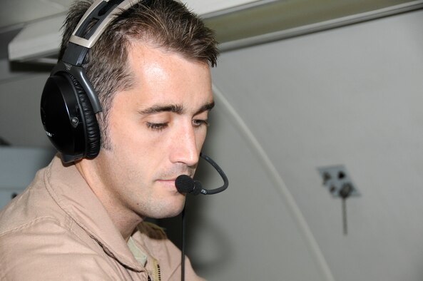 SOUTHWEST ASIA -- Flight Lt. Troy Roempke with the 965th Expeditionary Airborne Air Control Squadron performs a checkout of his communications system on an E-3 sentry here Dec. 24. He was preparing to fly his final mission at the 380th Air Expeditionary Wing before heading home to Australia. He has been with the 965th out of Tinker Air Force Base, Okla. for three years with the last four months in a deployed location gaining valuable frontline experience. While deployed with the 965th Flight Lieutenant Roempke has flown 20 missions in the area of responsibility in support of Operations Iraqi and Enduring Freedom. (U.S. Air Force photo/Tech. Sgt. Christopher A. Campbell) (released)
