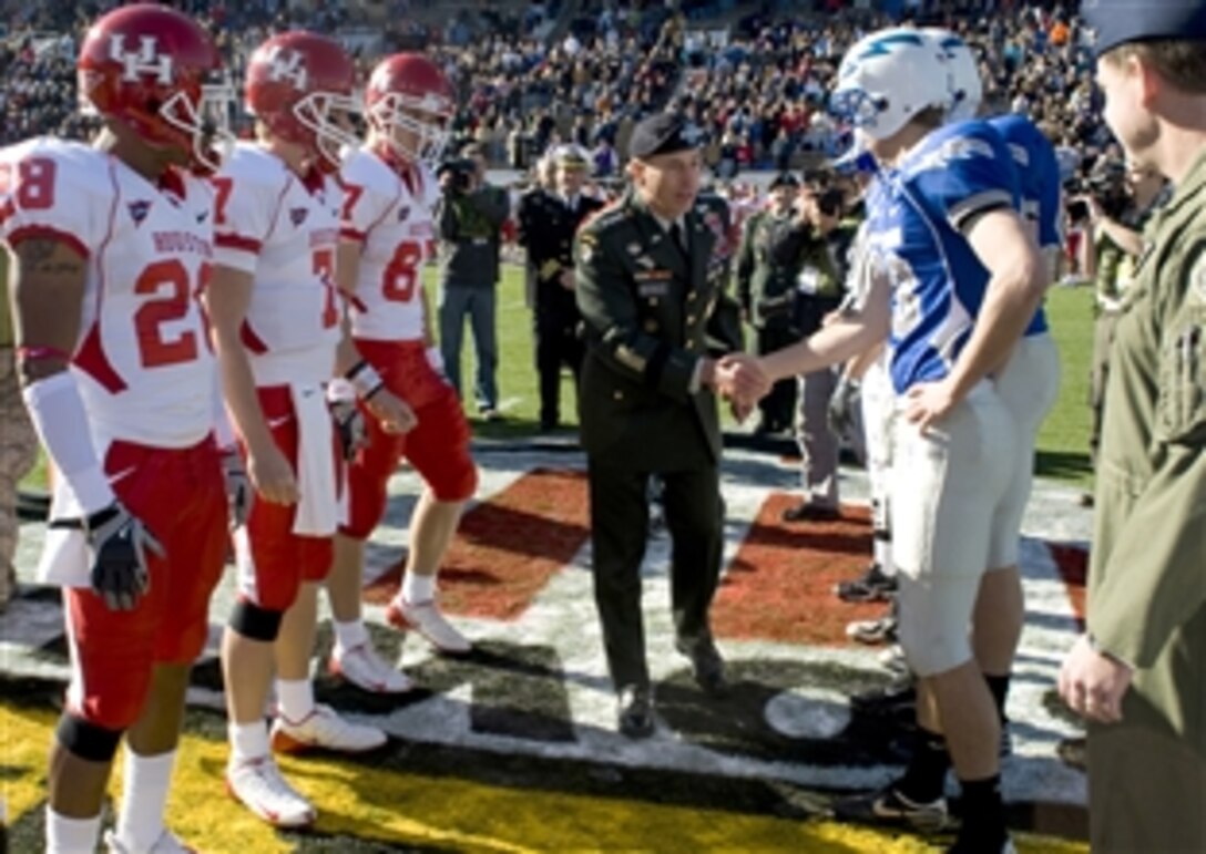 Army Gen. David H. Petraeus shakes hands with football players from the U.S. Air Force Academy and the University of Houston before the coin toss at the sixth annual Bell Helicopter Armed Forces Bowl in Fort Worth, Texas, Dec. 31, 2008. Petraeus performed the coin toss and was honored during the game's half-time event. Houston won, 34-28.