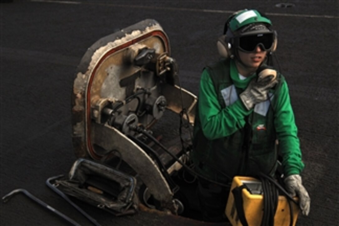 U.S. Navy Airman Melissa Pyle conducts a communications check on the flight deck aboard the aircraft carrier USS Theodore Roosevelt (CVN 71) while underway in the Gulf of Oman on Dec. 29, 2008.  