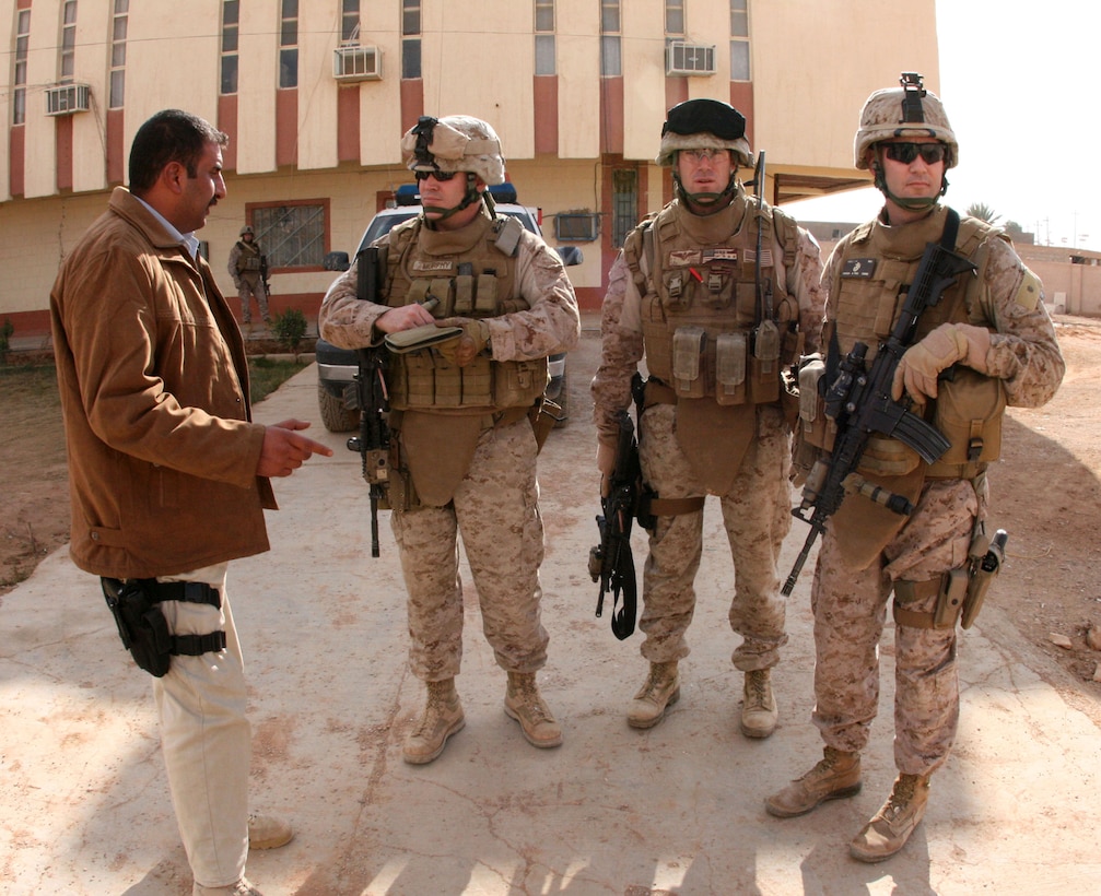 Marine Corps Reserve Maj. Timothy Murphy (second from left), the intelligence officer for 2nd Battalion, 25th Marine Regiment, interviews Iraqi Lt. Col. Ahmed of the National Information Investigation Agency here Dec. 31, 2008.  Murphy joined the Marine Corps as an infantryman in 1986 and later earned a commission.  He affiliated with the Marine Corps Reserve in 2003.  Maj. Craig Abele (right), served with Murphy as the battalion’s intelligence officer.  Abele, who has spent the past seven of his 16 years in the Corps as a reservist, is currently attending Marine Corps Command and Staff College full-time in Quantico, Va.  He is scheduled to graduate in June with a master’s degree in military science.
