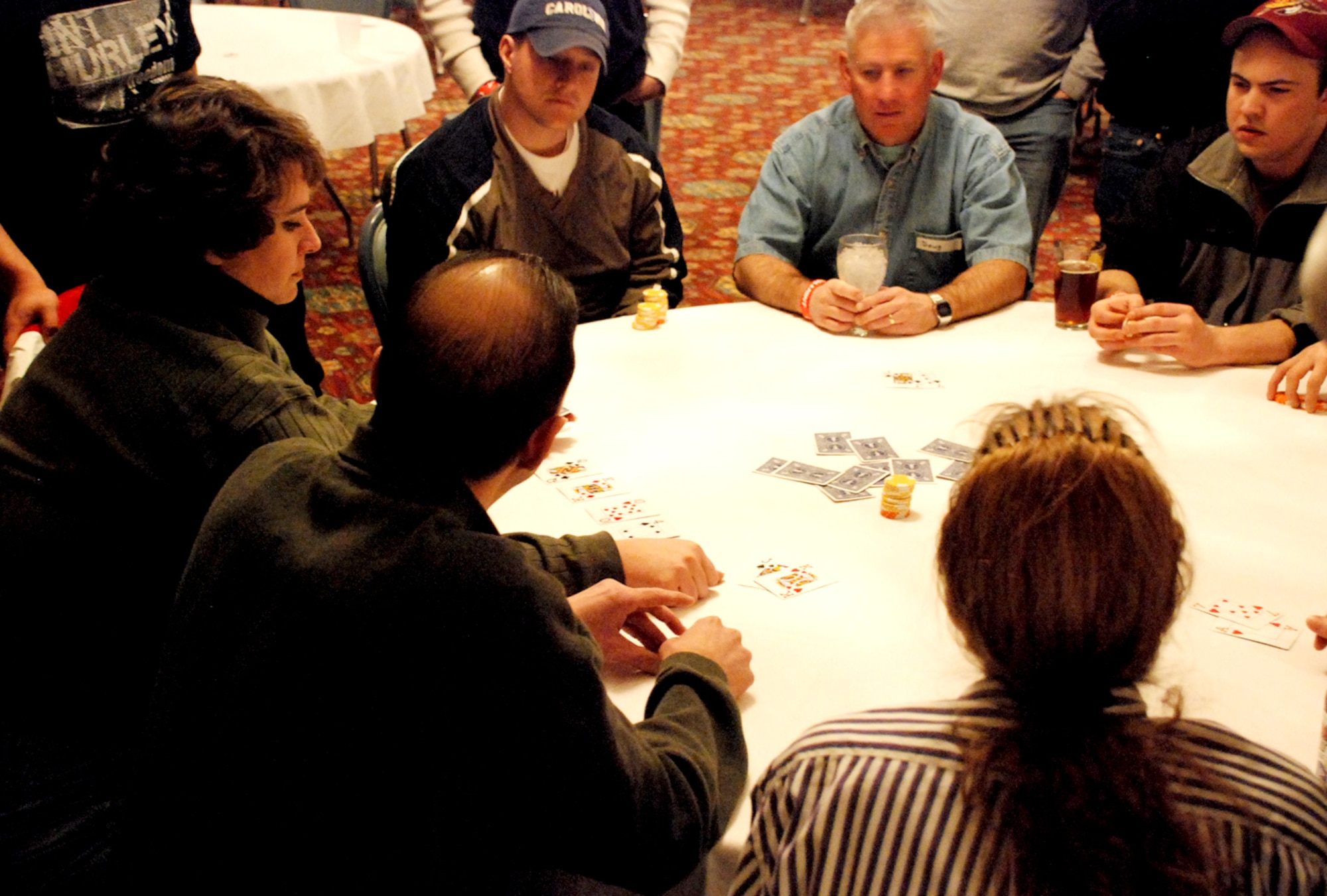 Warren members participate in a “Texas hold ‘em” poker tournament Saturday at the Trail’s End Club. Staff Sgt. Josh Moore, 153rd Command and Control Squadron, was the winner. Thirty-six members played in the event with fake money to win prizes. The final eight players received a mug, and the last four received prizes ranging from a $25 gift certificate to a local store, $50 AAFES certificate and a portable DVD player. The grand prize was a one-night stay at a local casino and $100 (U.S. Air Force photo/Staff Sgt. Chad Thompson).