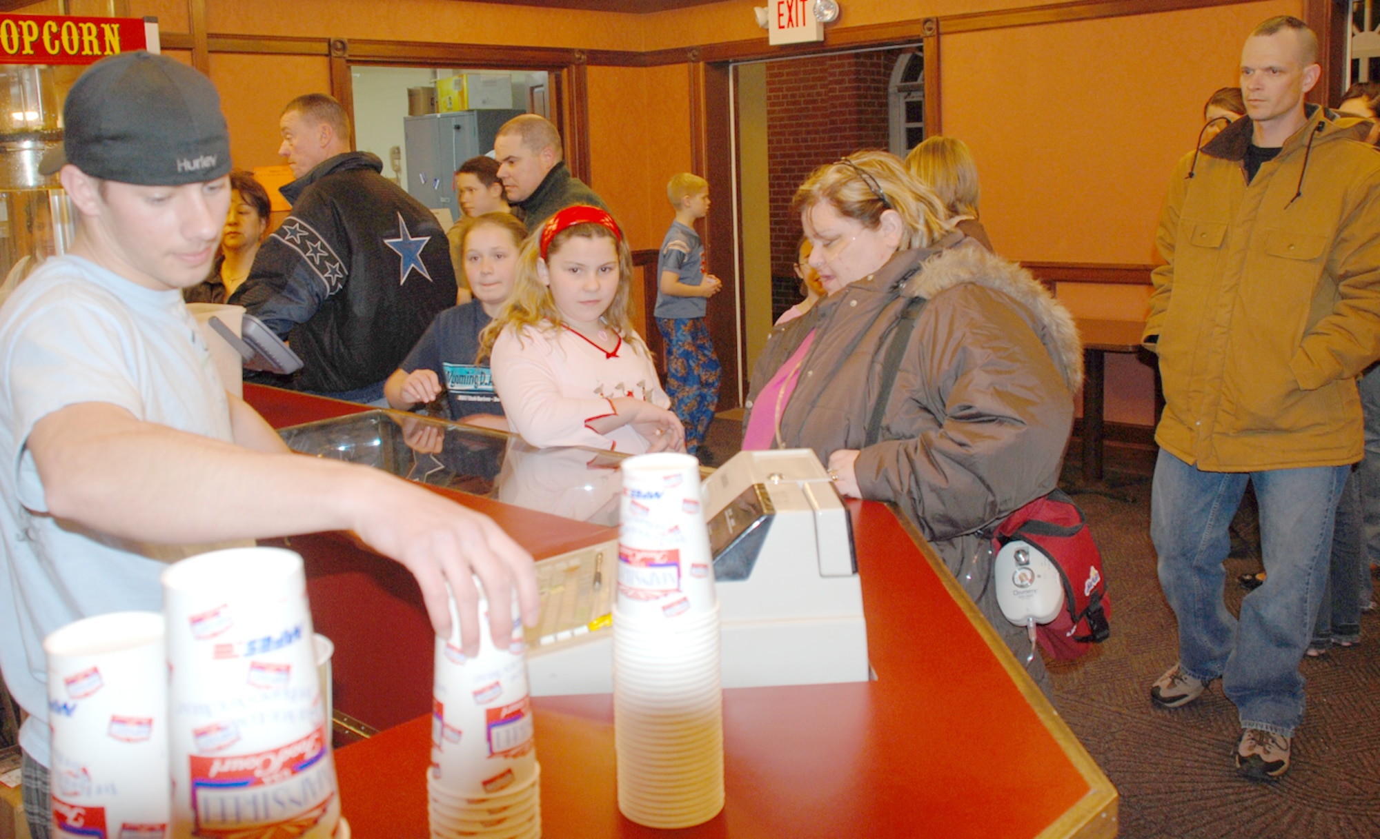 Devin Miller sells snacks and refreshments to movie goers Jan. 25. The Warren movie theater staff hosts a special event once a month with this month being Pajama Night. “Alvin and the Chipmunks” aired with more than 150 children in pajamas attending (U.S. Air Force photo/Airman 1st Class Daryl Knee).