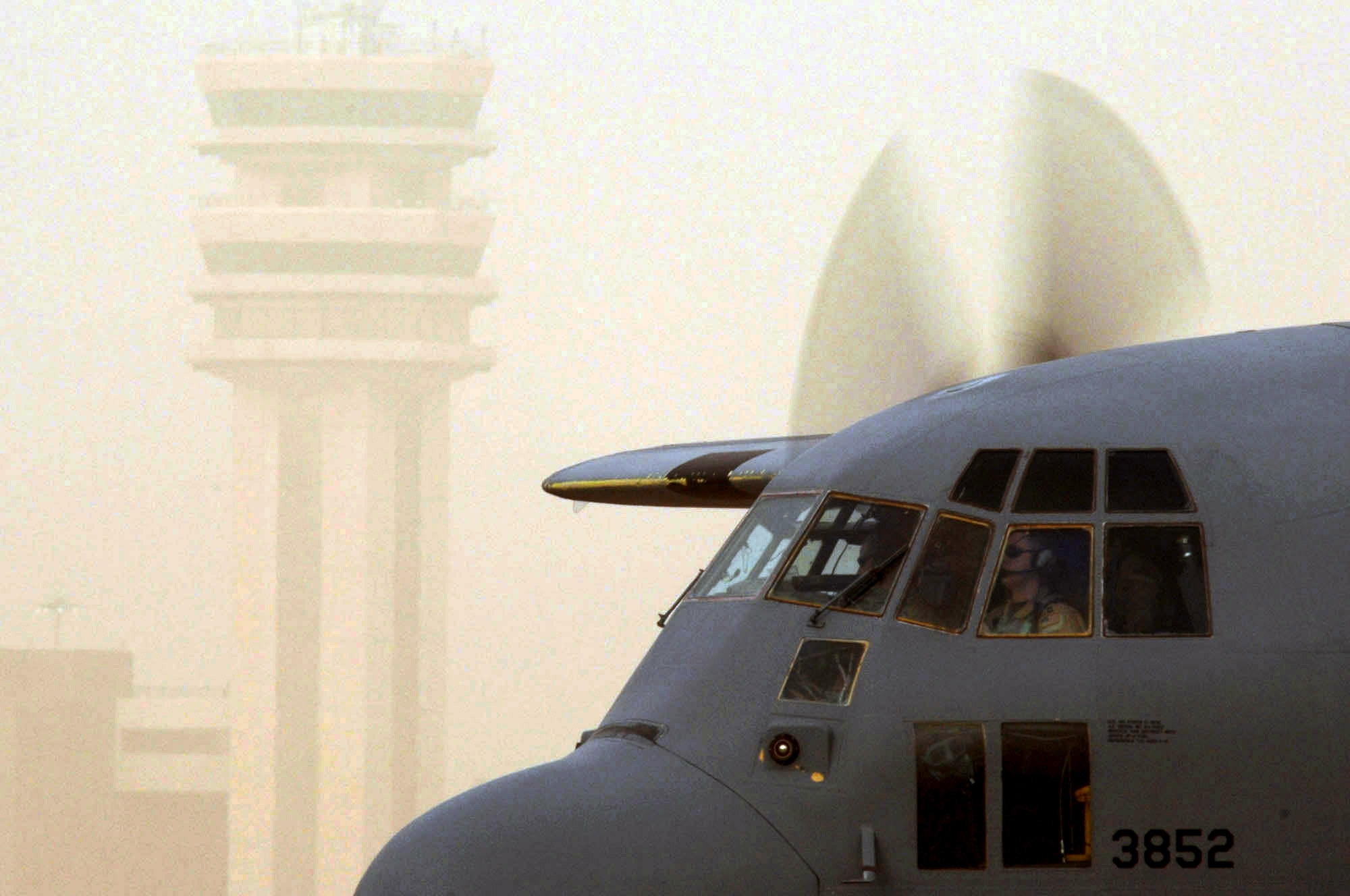 A C-130 Hercules taxies to a parking spot during a Jan. 30 dust storm at Sather Air Base, Iraq. Baghdad International Airport recently activated a instrument landing system, which allows pilots to use aircraft instruments to land in low visibility conditions like a dust storm. Sather AB is located on the west side of Baghdad International Airport and base Airmen move 6,200 passengers weekly and more than 1,700 tons of cargo weekly. (U.S. Air Force photo/Tech. Sgt. Jeffrey Allen) 
