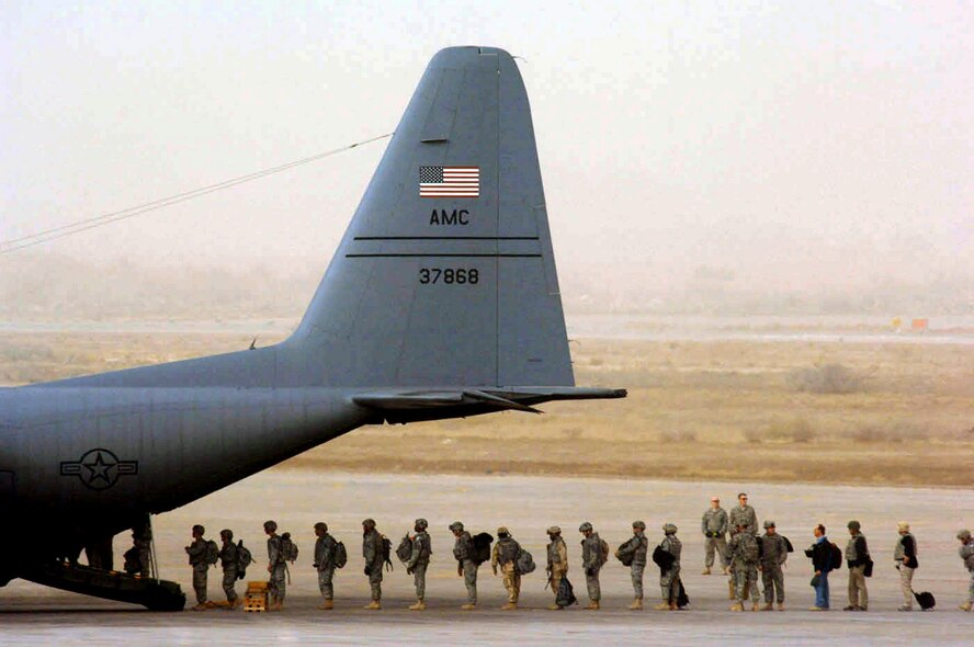 Personnel supporting Operation Iraqi Freedom load onto a C-130 Hercules during a dust storm Jan. 30 at Sather Air Base, Iraq. Sather AB is located on the west side of Baghdad International Airport and base Airmen move 6,200 passengers weekly and more than 1,700 tons of cargo weekly. (U.S. Air Force photo/Tech. Sgt. Jeffrey Allen) 