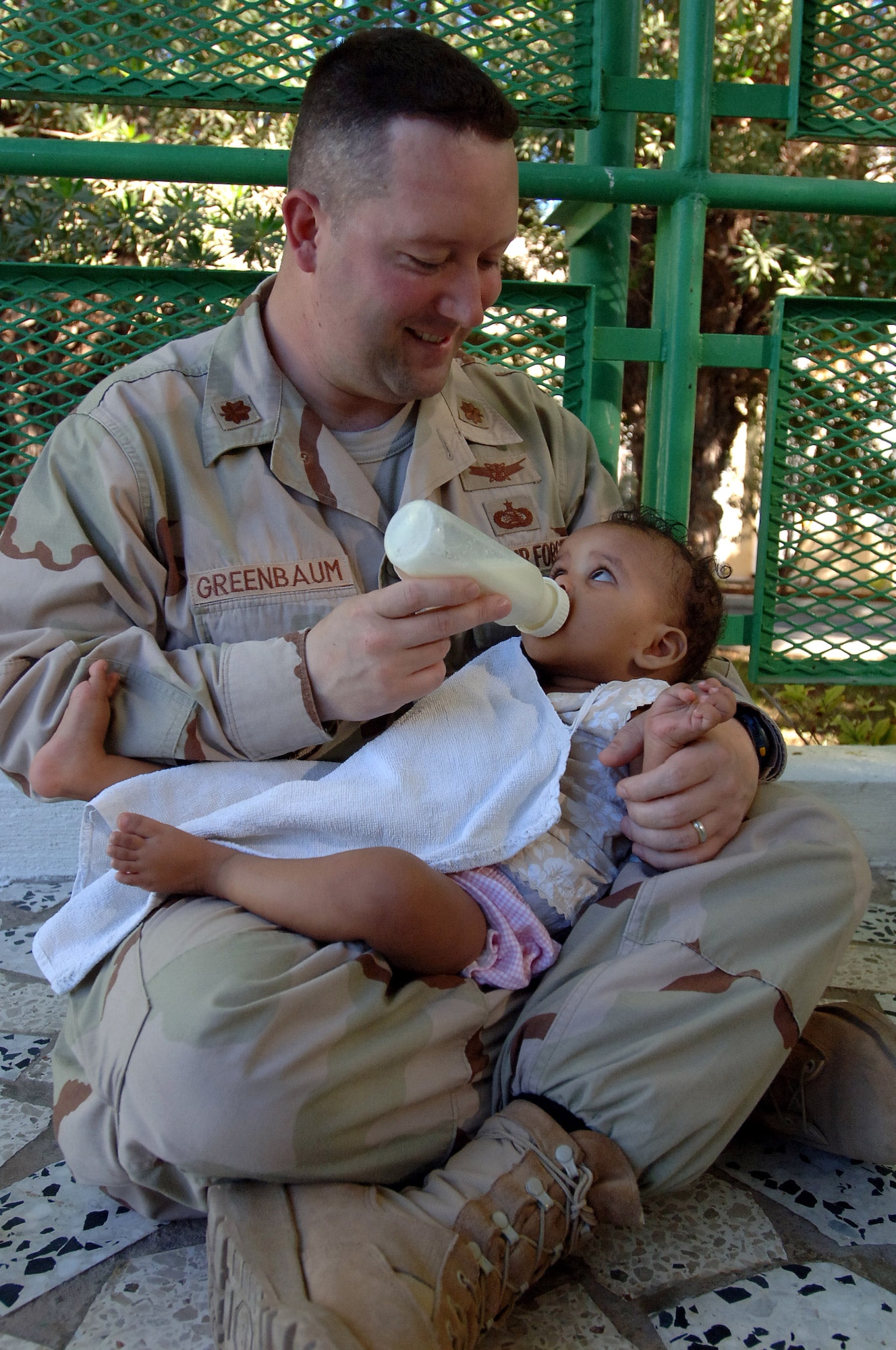 Maj. Lanny Greenbaum feeds a baby Jan. 26 during a visit to an orphanage in Djibouti. Servicemembers supporting the Combined Joint Task Force-Horn of Africa mission donate their time three times a week to help French nuns who run the facility feed the babies at dinner time. More than 60 babies and toddlers are cared for at the facility. Major Greenbaum, a Plain City, Ohio, native, is the CJTF-HOA information management officer. (U.S. Air Force photo/Staff Sgt. Jennifer Redente) 