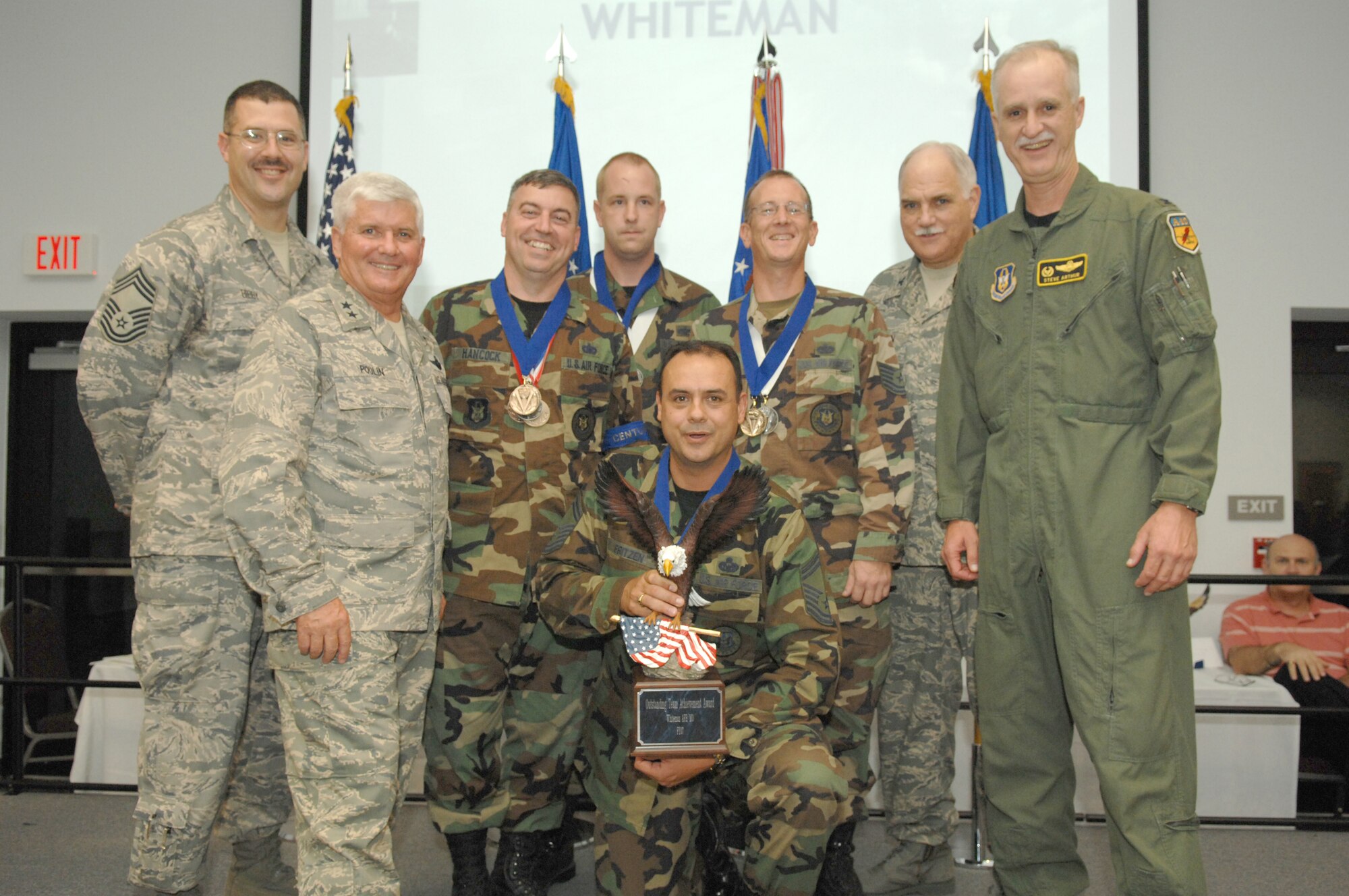 The 442nd Fighter Wing recruiting team  received the Outstanding Team Achievement Award for Recruiting Excellence as Air Force Reserve Command's top operating location. Posing for the award photo are Chief Master Sgt. Bibby, a former 442nd recruiter and the AFRC  Recruiting Service Manager; Major General Allan Poulin, AFRC vice commander; the 442nd Recruiting team members, Master Sgt. Jerry Hancock, Tech. Sgt. Clark Gilleo, Senior Master Sgt. James Fritzen (kneeling) and Tech. Sgt. John Manning; with Col.  Francis Mungavin, AFRC Recruiting Service commander and Col. Steve Arthur, 442nd FW commander.  (U.S. Air Force photo/courtesy AFRC/RS)