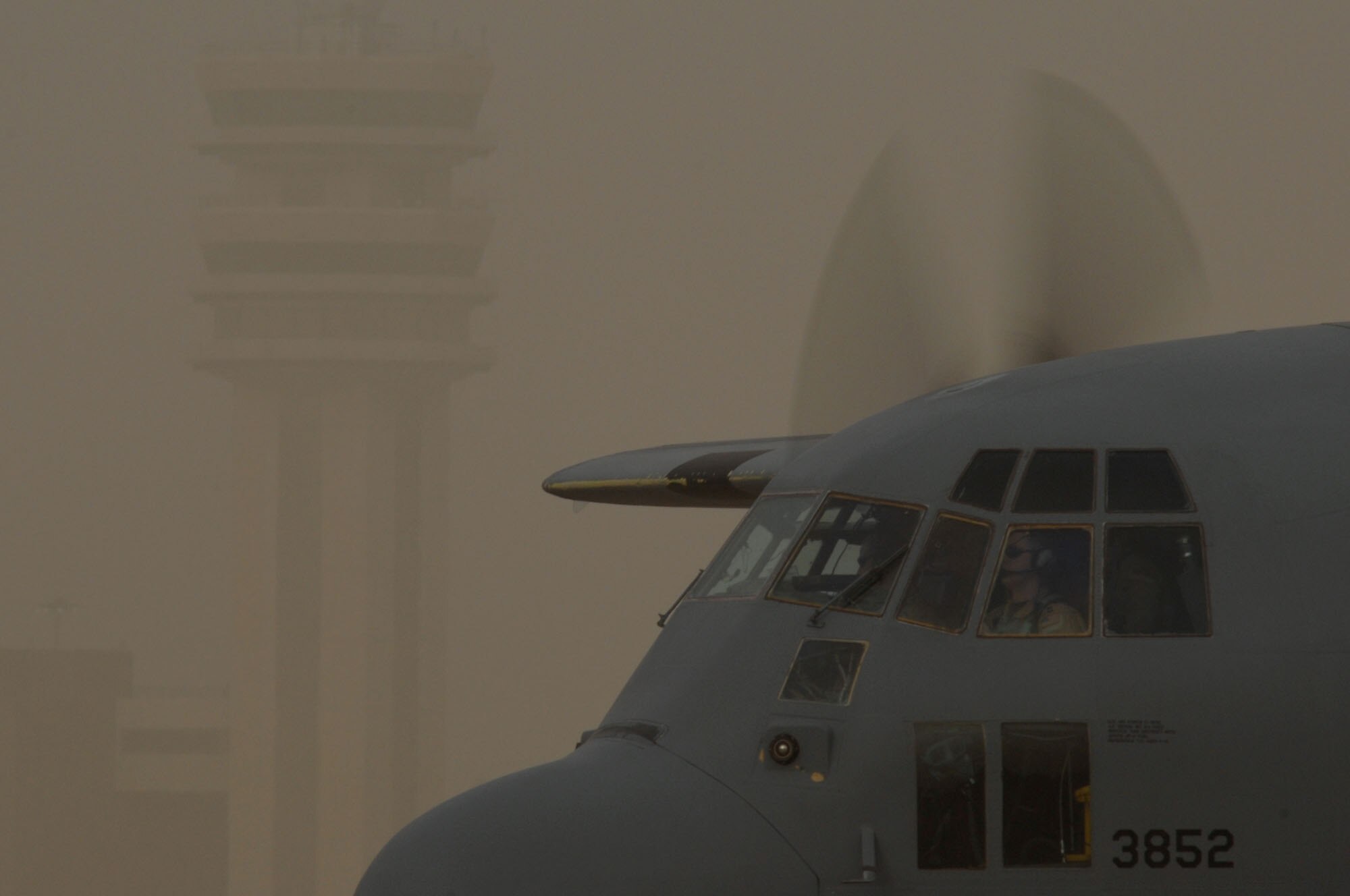 A C-130 Hercules taxis to parking during a dust storm at Sather Air Base, Iraq, on January 30, 2008.Baghdad International Airport recently activated a Instrument Landing System (ILS) which allows pilots to use aircraft instruments to land in low visibility conditions like a dust storm. Sather AB is located on the west side of Baghdad International Airport and is the largest mover of passengers in Iraq, averaging 6,200 passengers weekly and the second largest mover of cargo in Iraq, averaging more than 1,700 tons weekly. (U.S. Air Force photo by Tech. Sgt. Jeffrey Allen)
