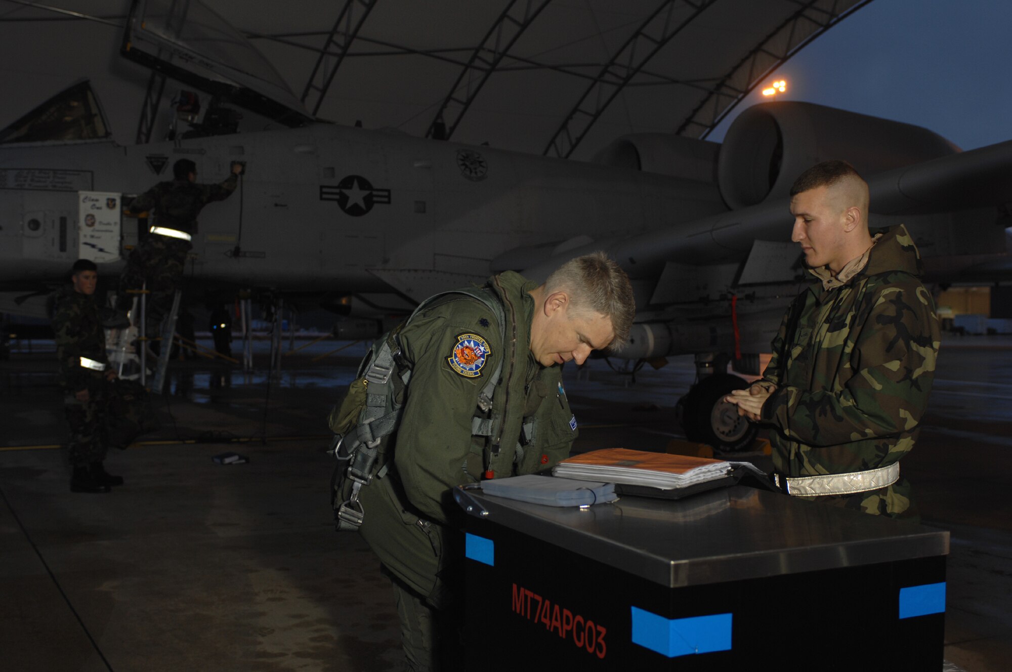 MOODY AIR FORCE BASE, Ga. -- Airman 1st Class Kenneth Marthey, 23rd Aircraft Maintenance Squadron crew chief, briefs Lt. Col. Philip Wielhouwer, 74th Fighter Squadron commander, on the preflight status of his A-10C Thunderbolt II before a mission here Feb. 1.  This is the inaugural A-10C flight for the 74th FS at Moody. (U.S. Air Force photo by Senior Airman Angelita Lawrence)