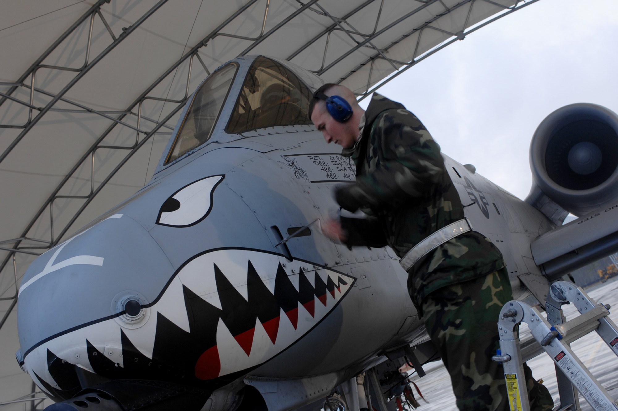 MOODY AIR FORCE BASE, Ga. -- Airman 1st Class Kenneth Marthey, 23rd Aircraft Maintenance Squadron crew chief, unscrews a maintenance access panel on a 74th Fighter Squadron A-10C Thunderbolt II here Feb. 1.  The aircraft was attempting to participate in the inaugural A-10C sortie for the 74th FS at Moody. (U.S. Air Force photo by Senior Airman Angelita Lawrence)