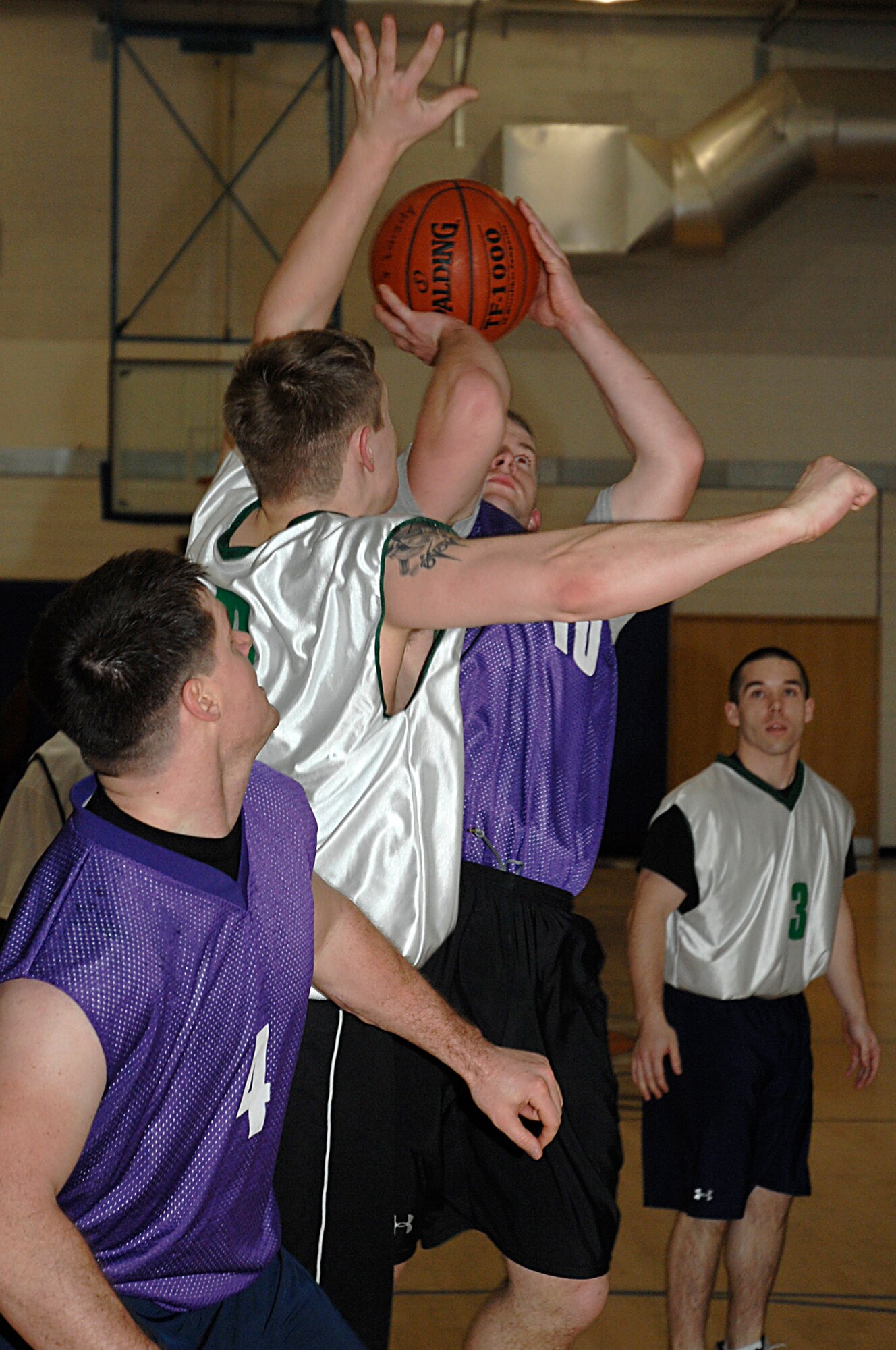 Jason Madigan, 48th Civil Engineer Squadron, pulls up for a shot during an intramural basketball game Jan. 30 at RAF Lakenheath, England. The 48th CES beat the 48th Communication Squadron 51-34. (U.S. Air Force photo by Senior Airman Brian Ellis)