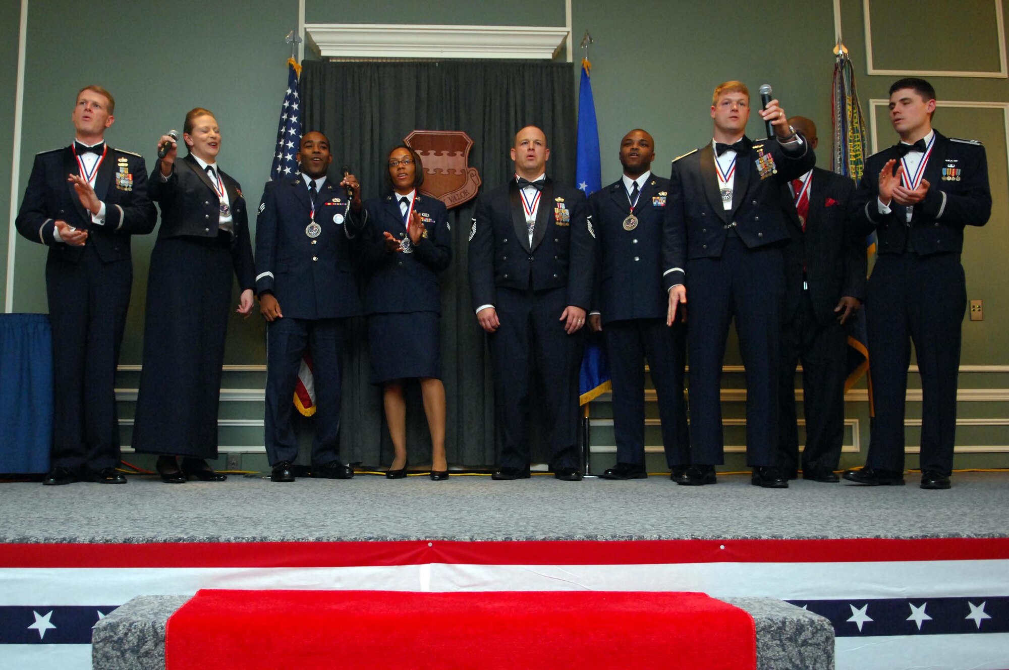 SHAW AIR FORCE BASE, S.C. -- 20th Fighter Wing annual award winners sing the Air Force Song Jan. 26 at the conclusion the 20th FW Annual Awards banquet at the Carolina Skies Club. The winners will continue on to compete at the Numbered Air Force Level. (U.S. Air Force photo/Airman 1st Class Kathrine McDowell)
