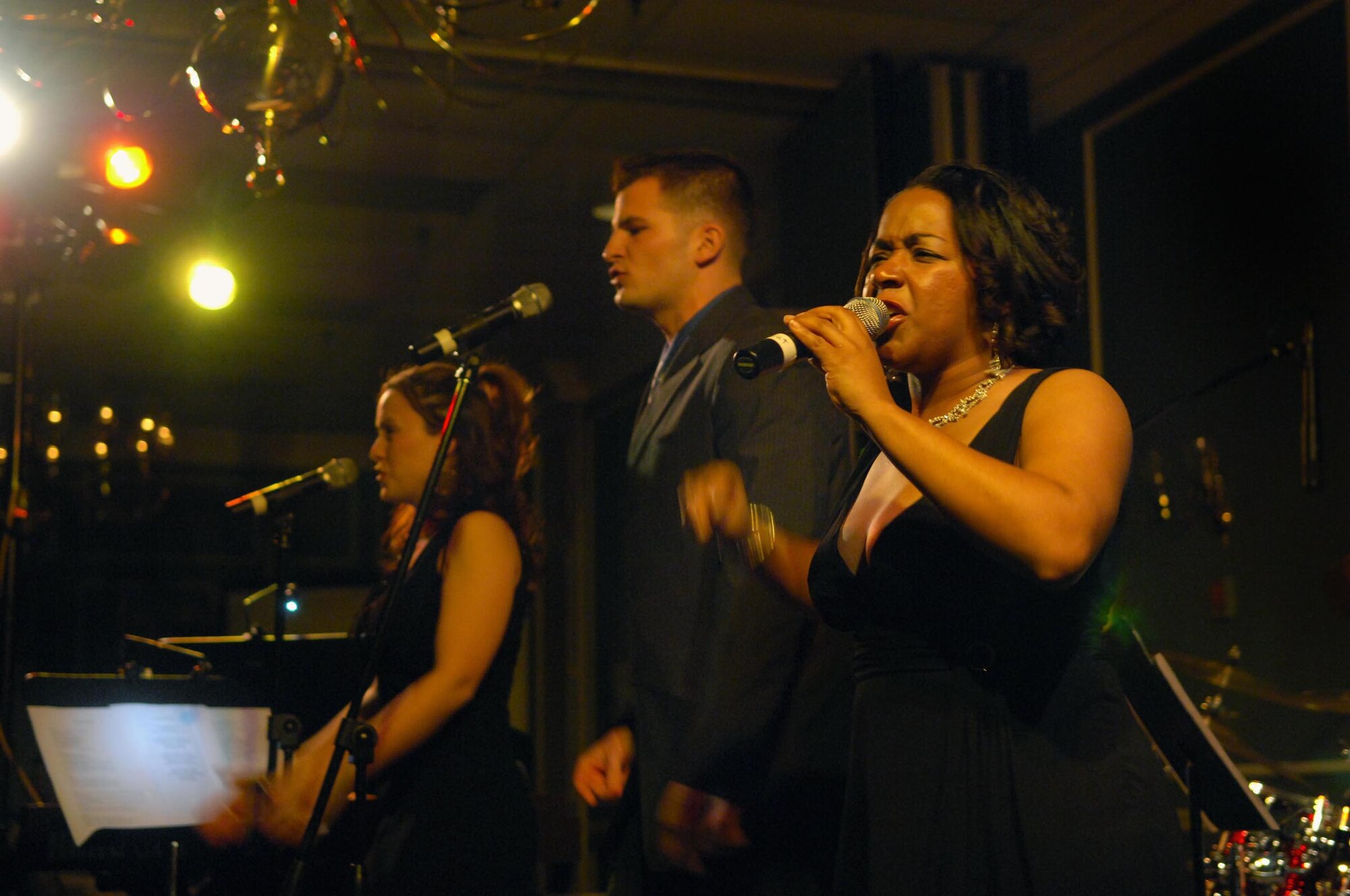 SHAW AIR FORCE BASE, S.C. -- The U.S. Air Force Heritage Band: Blue Aces vocalists Tech. Sgt. Becky Wolf, Staff Sgt. Craig Bowman and Staff Sgt. Natalie Madison, entertain the crowd during the 20th Fighter Wing Annual Banquet Jan. 26 at the Carolina Skies Club. (U.S. Air Force photo/Airman 1st Class Kathrine McDowell)