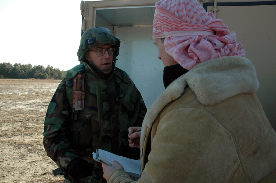 Col. Lee Gardner, 2nd Mission Support Group commander from Barksdale Air Force Base, La., and the deployed commander for the fictional 421st Air Expeditionary Group, talks with a "local media" reporter, played by Senior Airman Clayton Murray of the 75th Fighter Wing public affairs office, Hill AFB, Utah, during a scenario for Air Force Exercise Eagle Flag 08-2 Jan. 21, 2008, at Naval Air Engineering Station Lakehurst, N.J.  The exercise is operated by the U.S. Air Force Expeditionary Center's Expeditionary Operations School and 421st Combat Training Squadron from Fort Dix, N.J.  (U.S. Air Force Photo/Tech. Sgt. Scott T. Sturkol)
