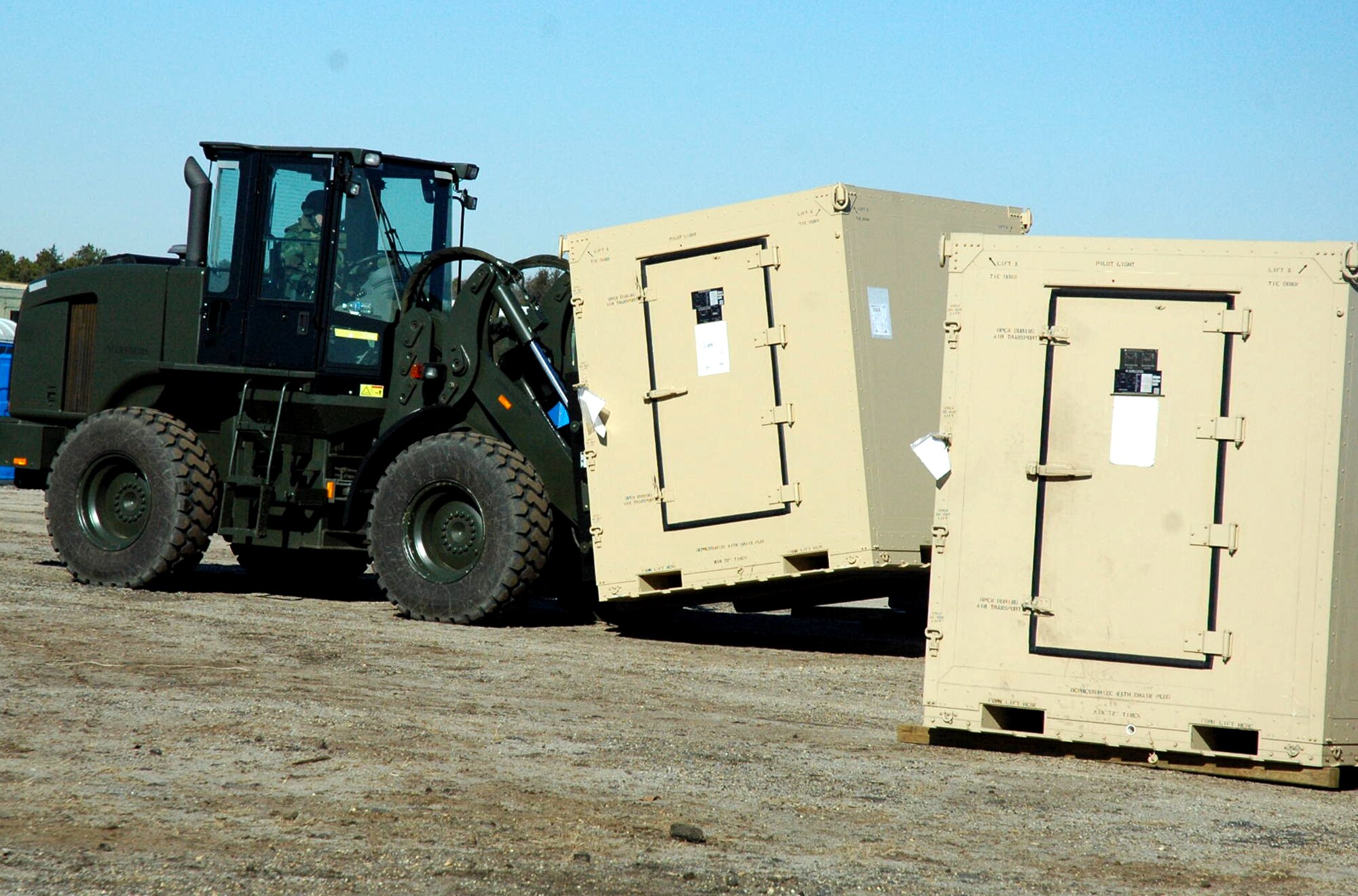 An Airman assigned to the fictional 421st Air Expeditionary Group uses an extreme terrain forklift to move cargo during camp build-up for Air Force Exercise Eagle Flag 08-2 Jan. 21, 2008, at Naval Air Engineering Station Lakehurst, N.J.  The exercise is operated by the U.S. Air Force Expeditionary Center's Expeditionary Operations School and 421st Combat Training Squadron from Fort Dix, N.J.  (U.S. Air Force Photo/Tech. Sgt. Scott T. Sturkol)