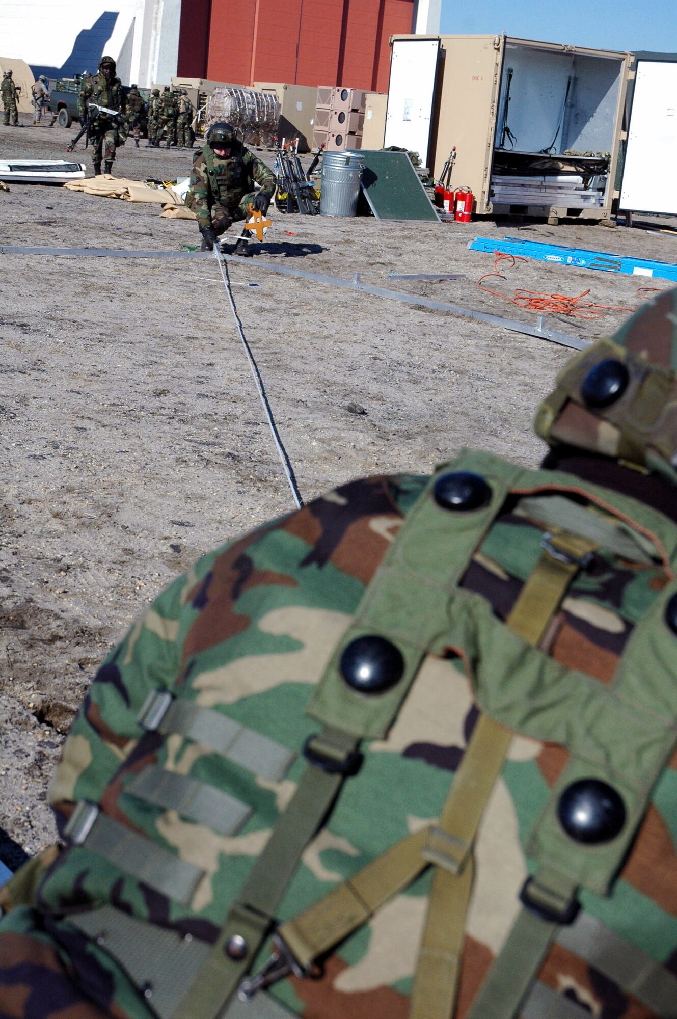 Airmen assigned to the fictional 421st Air Expeditionary Group measure out space for an Alaskan shelter during camp build-up for Air Force Exercise Eagle Flag 08-2 Jan. 21, 2008, at Naval Air Engineering Station Lakehurst, N.J.  The exercise is operated by the U.S. Air Force Expeditionary Center's Expeditionary Operations School and 421st Combat Training Squadron from Fort Dix, N.J.  (U.S. Air Force Photo/Tech. Sgt. Scott T. Sturkol)