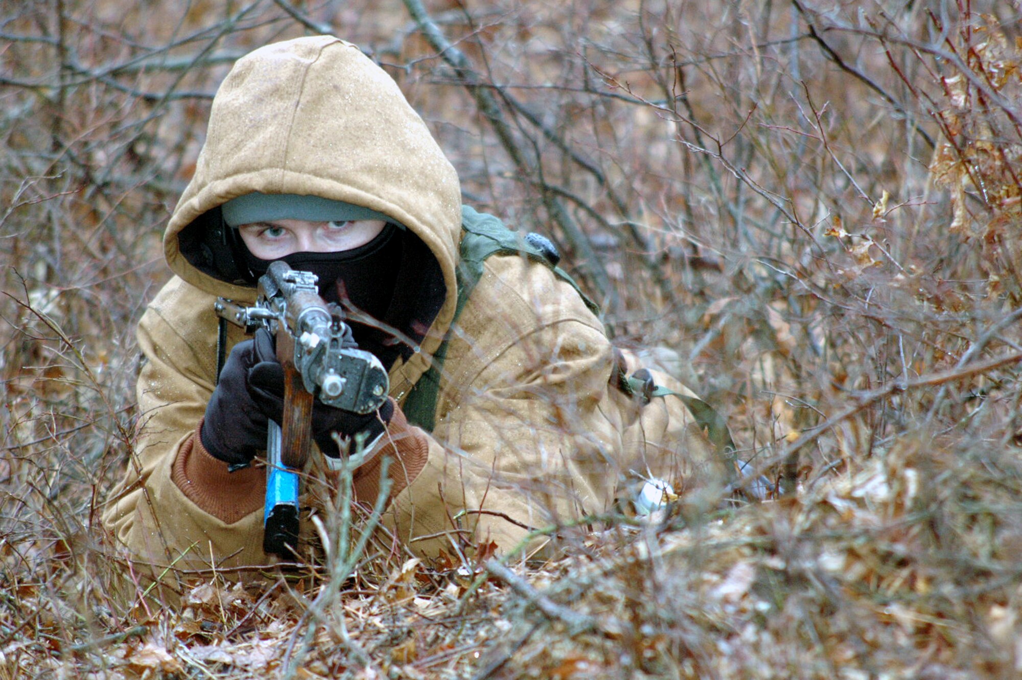 A U.S. Air Force Airman, playing the role of opposing forces, gets into position for an "ambush" on a convoy training route for the Air Force Phoenix Warrior Training Course 08-2 course Jan. 22, 2008, at Naval Air Engineering Station Lakehurst, N.J.  The course is taught by the U.S. Air Force Expeditionary Center's Expeditionary Operations School and the 421st Combat Training Squadron from Fort Dix, N.J.  (U.S. Air Force Photo/Tech. Sgt. Scott T. Sturkol)