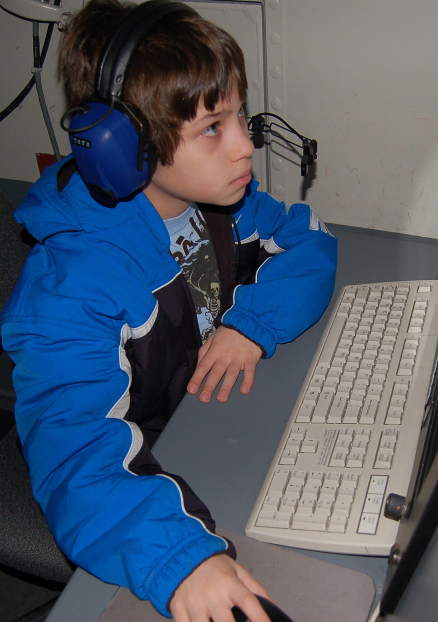 SPANGDAHLEM AIR BASE, Germany – AJ Coppersmith, son of Maj. Tom Coppersmith, 606th Air Control Squadron, spent his time during Job Shadow Day at the 606th ACS. The best part of his was talking to “pilots” over the headsets. (U.S. Air Force photo/Staff Sgt. Tammie Moore)