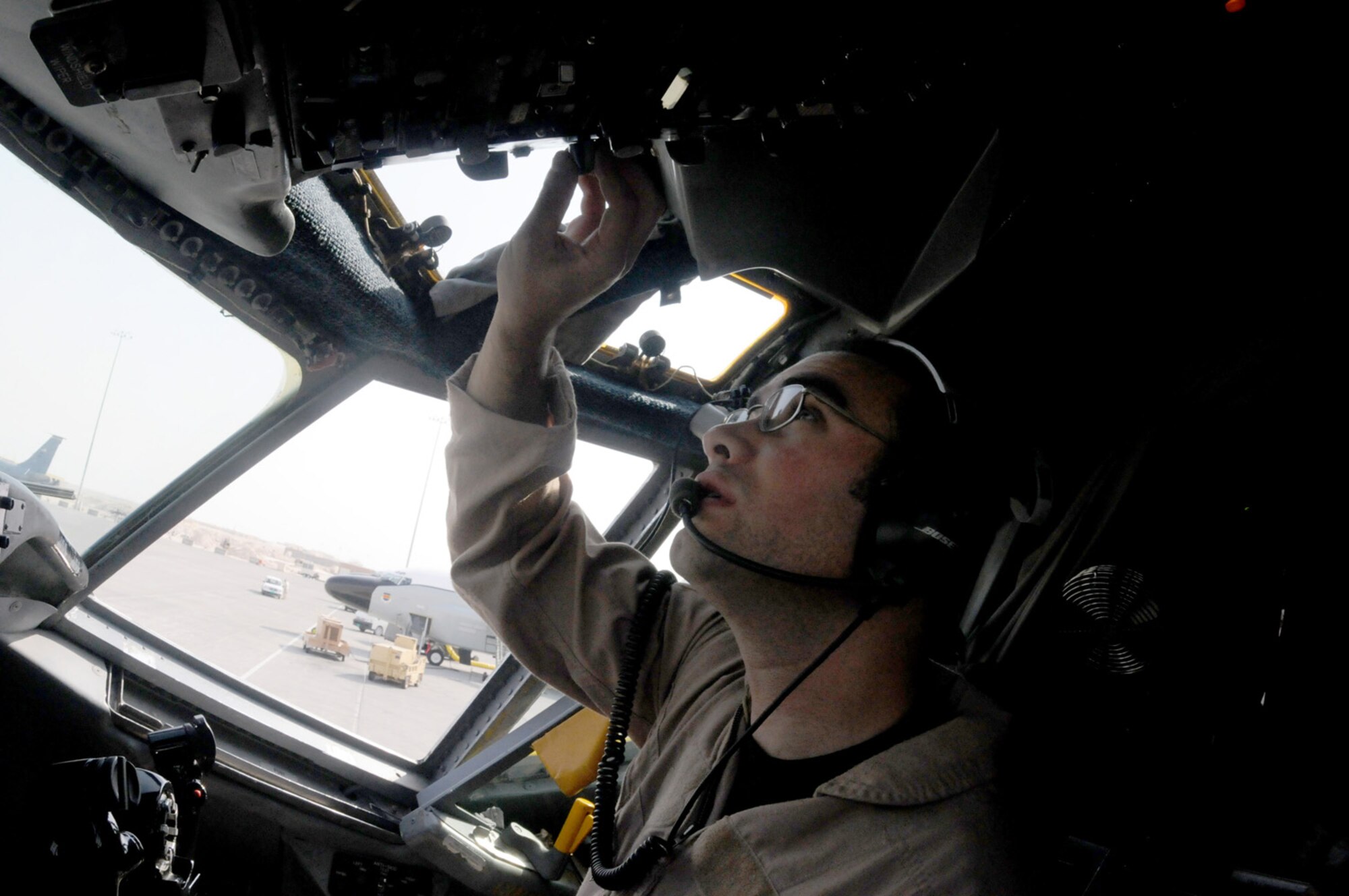 First Lt. Jonathon George, co-pilot of a RC-135 Rivet Joint aircraft, tests equipment in preparation for take off Jan. 30. He is part of the 763rd Expeditionary Reconnaissance Squadron.  (U.S. Air Force photo/Senior Airman Domonique Simmons)