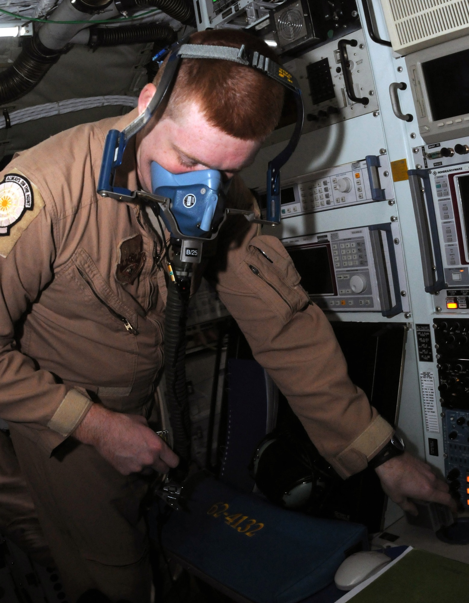 Staff Sgt. William Bryan, an airborne systems engineer from the 763rd Expeditionary Reconnaissance Squadron, checks a mask's oxygen flow inside an RC-135 Rivet Joint aircraft Jan. 30.  Sergeant Bryan is deployed to Southwest Asia from Offutt Air Force Base. (U.S. Air Force photo/Senior Airman Domonique Simmons)