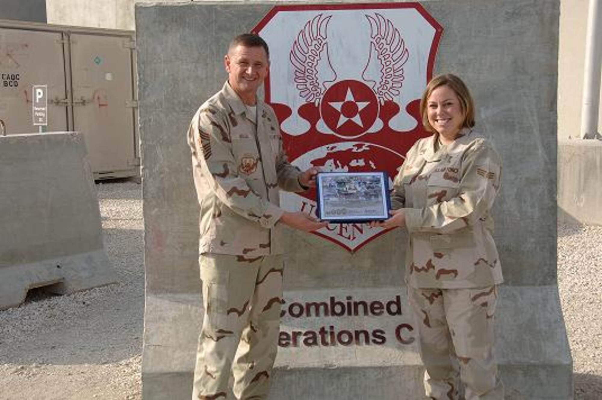 379 Air Expeditionary Wing Command Chief, Chief Master Sgt. Lloyd Hollen presnts Senior Airman Kendra M. Krepp with the December Hard Charger, Airman category,  award. (Courtesy photo)