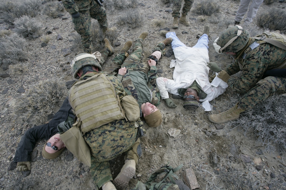 Two U.S. Marines with Embedded Trainer Team 5-3, an Okinawa, Japan, -based unit, treat role-playing wounded Afghani soldiers at a casualty collection point during a mass casualty training scenario Feb. 2, 2008, in Hawthorne, Nev.  U.S. Marines and sailors with Embedded Trainer Teams, all serving with 3rd Marine Division, executed a training lane aboard U.S. Army training grounds surrounding Hawthorn Army Depot that involved mass casualty evacuation, immediate action to improvised explosive devices and ambush counterattacks.  The training lane is part of a pre-deployment package dubbed Mountain Viper.  ETT 5-3 are preparing for an upcoming deployment to Afghanistan where they?ll be tasked with mentoring, monitoring and advising Afghan army units to become a self-capable military force.  (U.S. Marine Corps photo by Cpl. Michael S. Cifuentes)