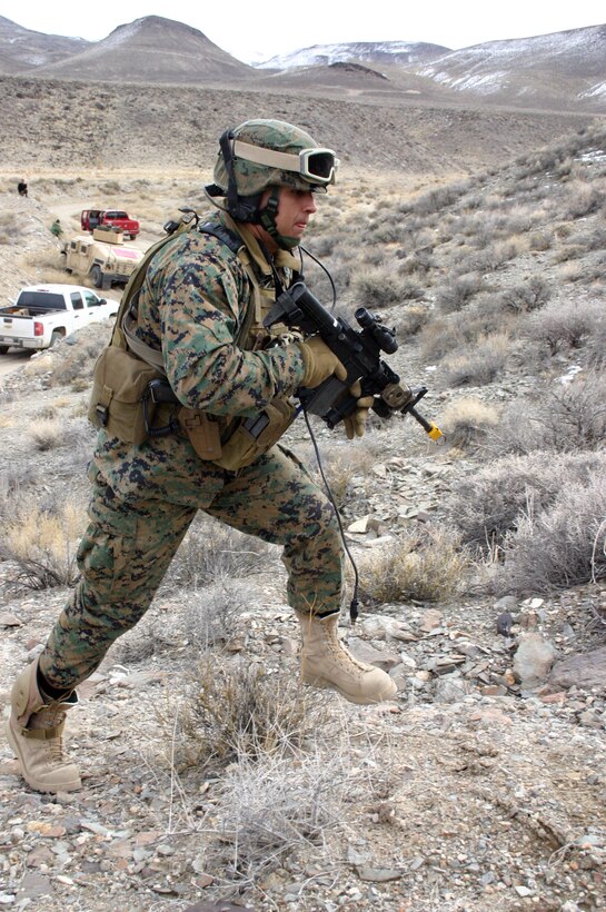 U.S Marine Staff Sgt. Alex A. Magedaleno, a communications chief with Embedded Trainer Team 5-3, climbs up a hill to scout for possible enemy assault during a convoy assault training scenario in Hawthorne, Nev., Feb. 2, 2008.  U.S. Marines and sailors with Embedded Trainer Teams, all serving with 3rd Marine Division, executed a training lane aboard U.S. Army training grounds surrounding Hawthorn Army Depot that involved mass casualty evacuation, immediate action to improvised explosive devices and ambush counterattacks.  The training lane is part of a pre-deployment package dubbed Mountain Viper.  ETT 5-3 are preparing for an upcoming deployment to Afghanistan where they?ll be tasked with mentoring, monitoring and advising Afghan army units to become a self-capable military force.  (U.S. Marine Corps photo by Lance Cpl. Uriel De Luna-Felix)