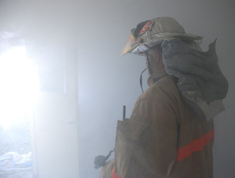 932nd Airlift Wing firefighters constantly practice to stay ready.  Here, a firefighter looks ahead to simulated smoke to understand how his field of vision and awareness of surroundings is affected by thick smoke.  Interested in the Air Force Reserve Command firefighting program?  Call 1-800-257-1212 for more information on openings and training required.  Photo/Capt. Stan Paregien
